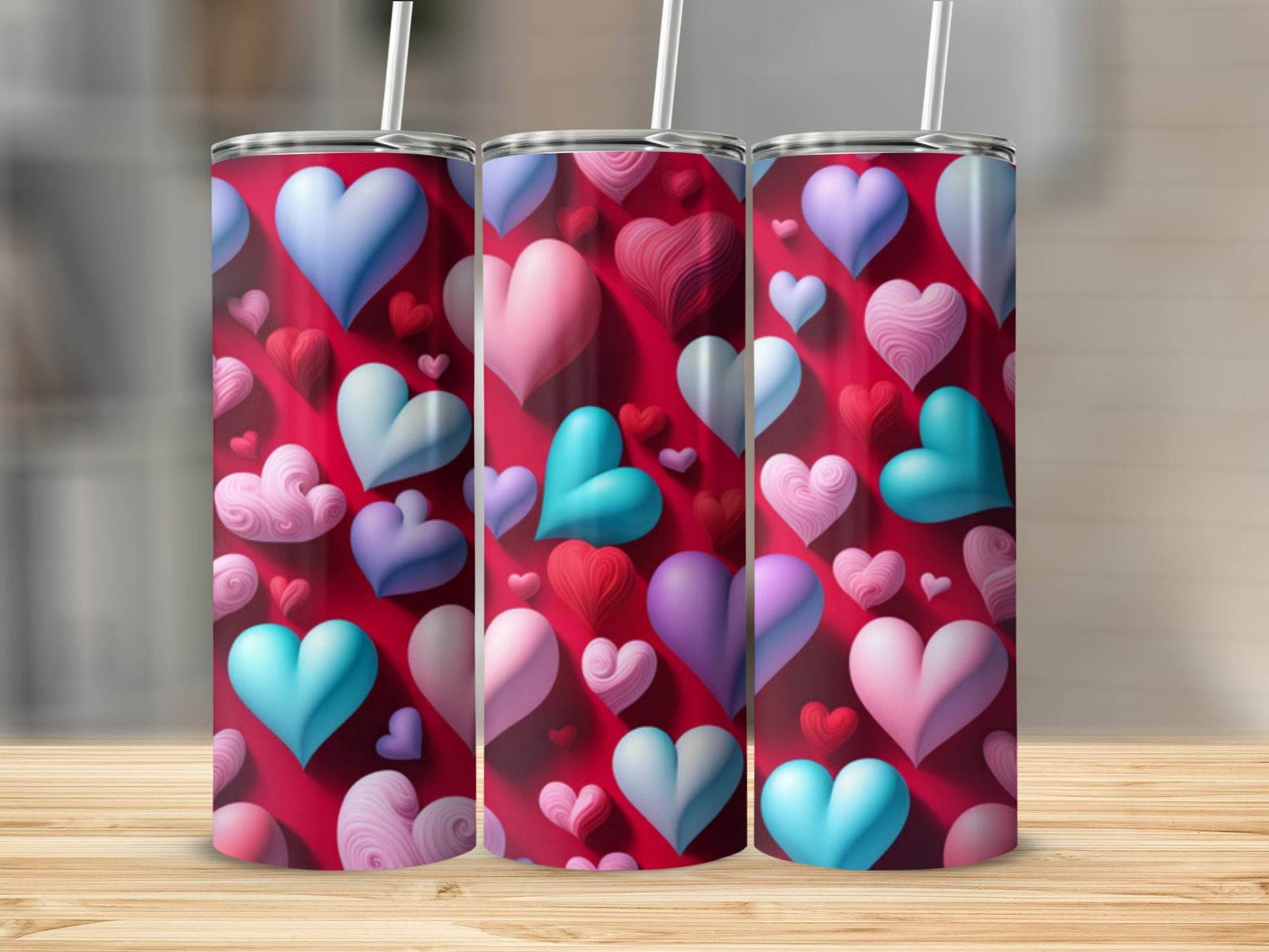 Three Valentine's Day tumblers with colorful heart pattern.