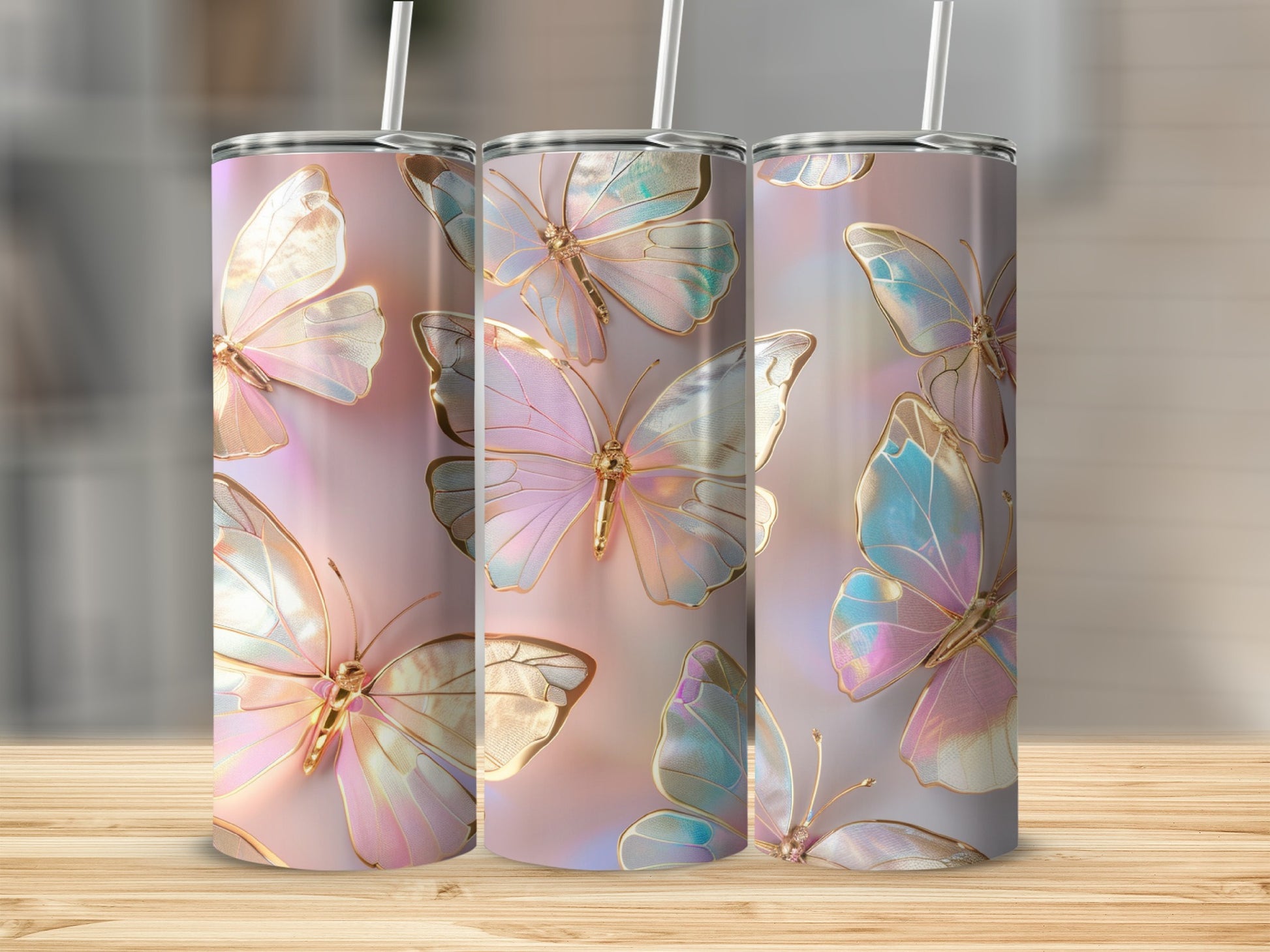 Three tumblers with iridescent butterfly designs stand on a wooden surface.