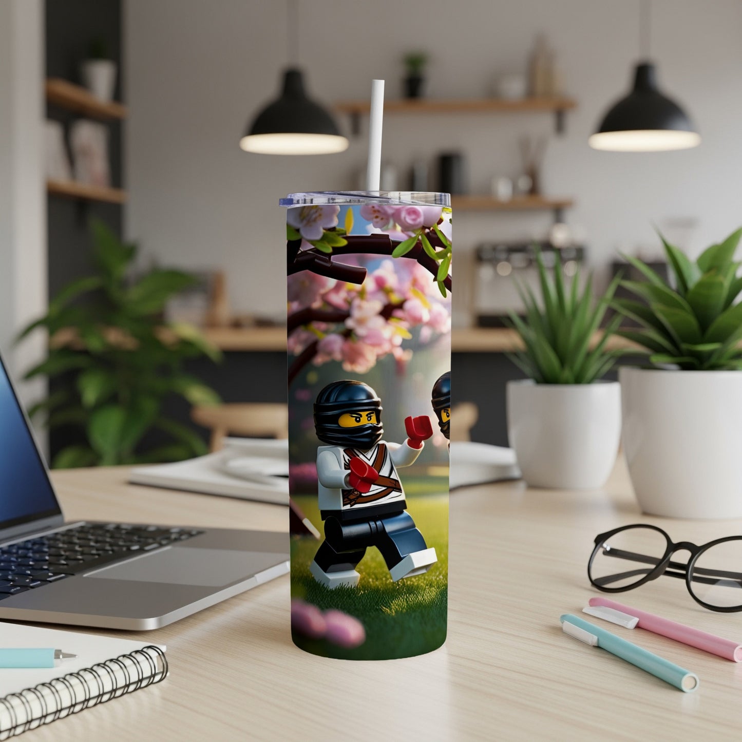 Ninja minifigure on a tumbler, surrounded by cherry blossoms and grass.