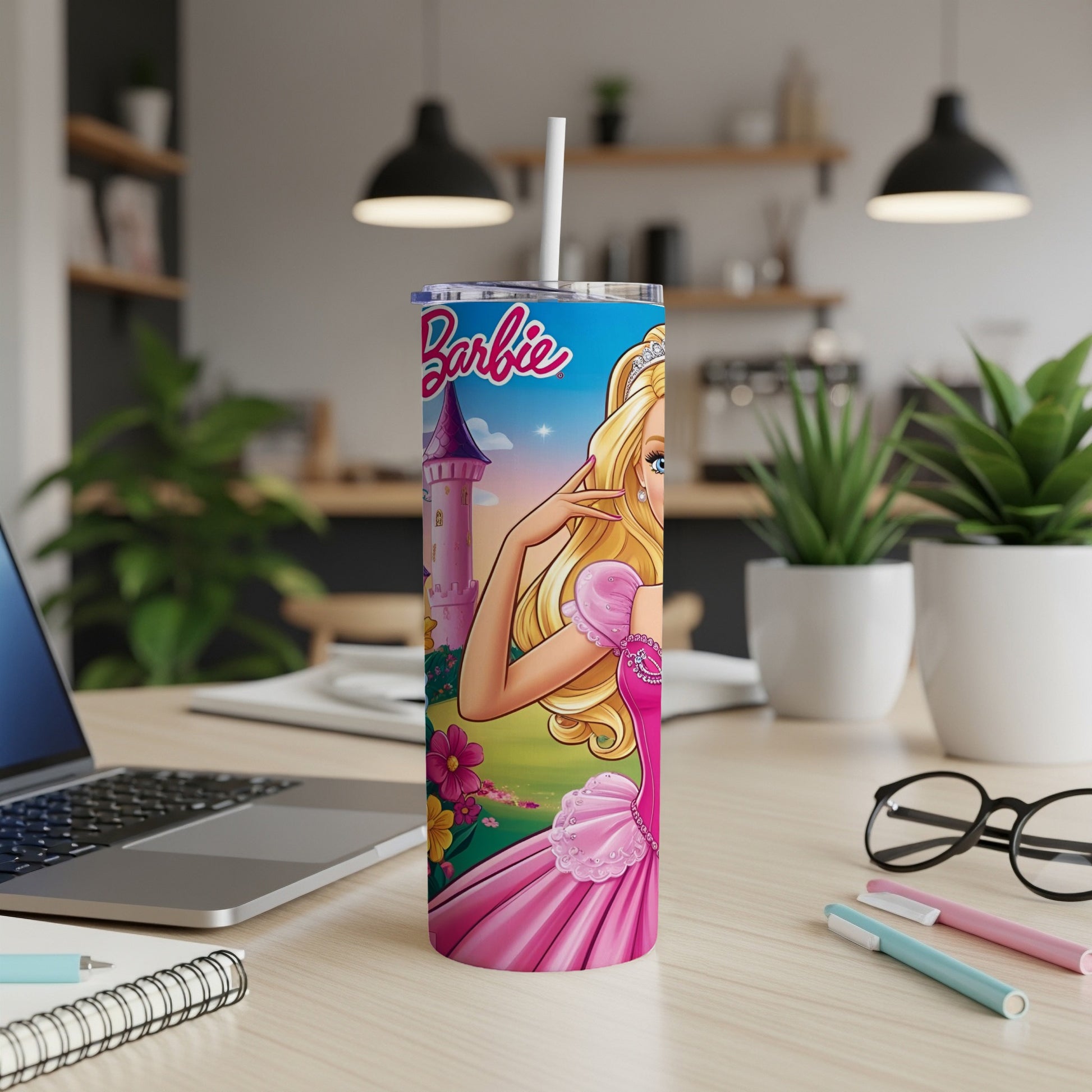 Barbie tumbler with castle and flowers on desk.