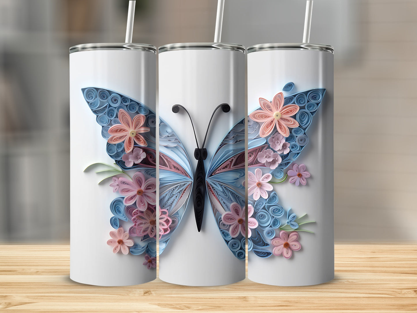 Three tumblers featuring a quilled paper butterfly with pink and blue flowers.