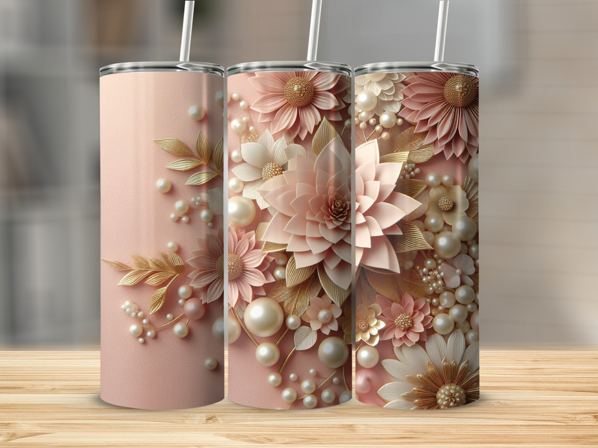 Three rose gold tumblers with delicate floral and pearl embellishments.