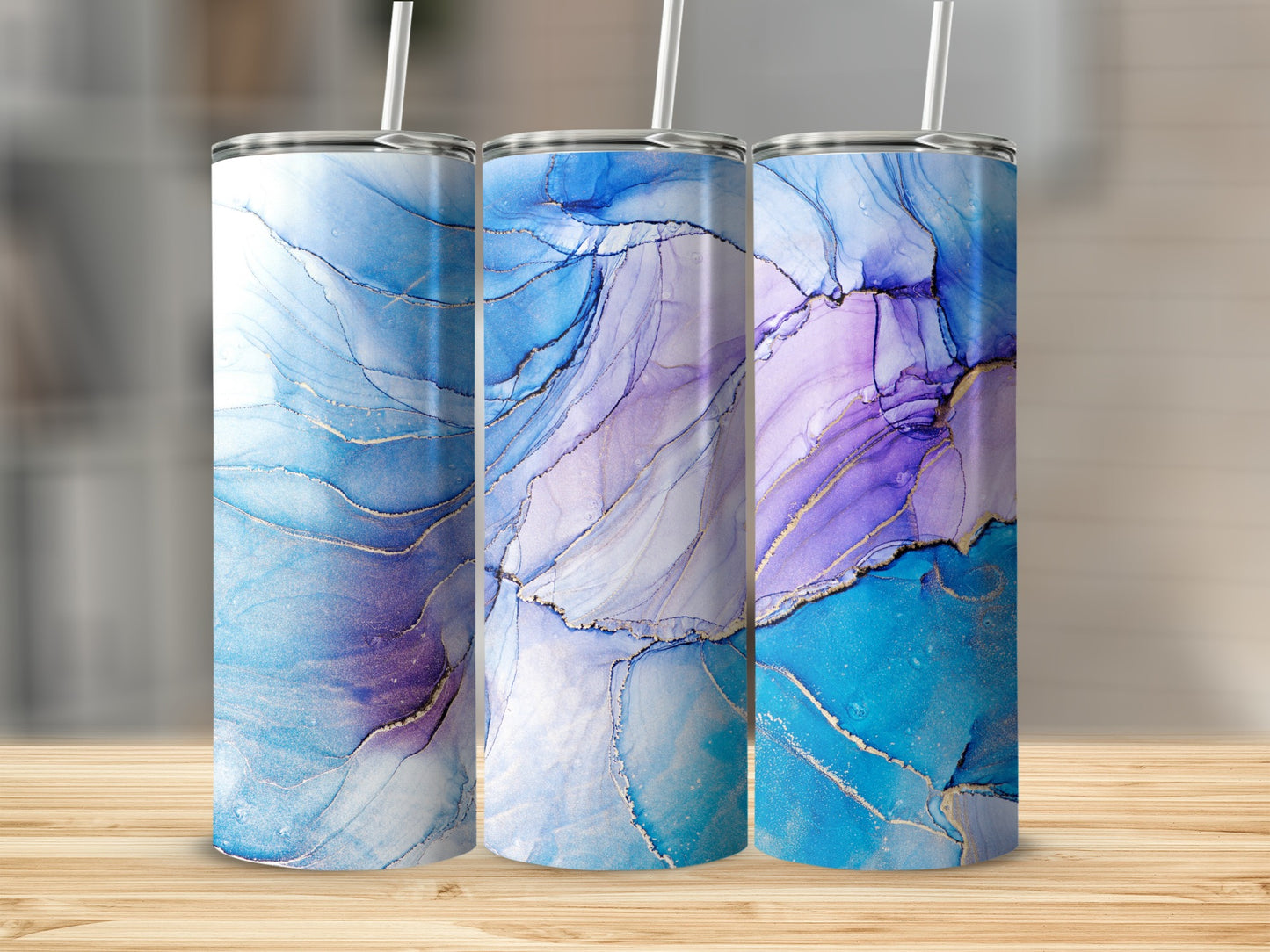 Three tumblers with blue and purple abstract watercolor designs.