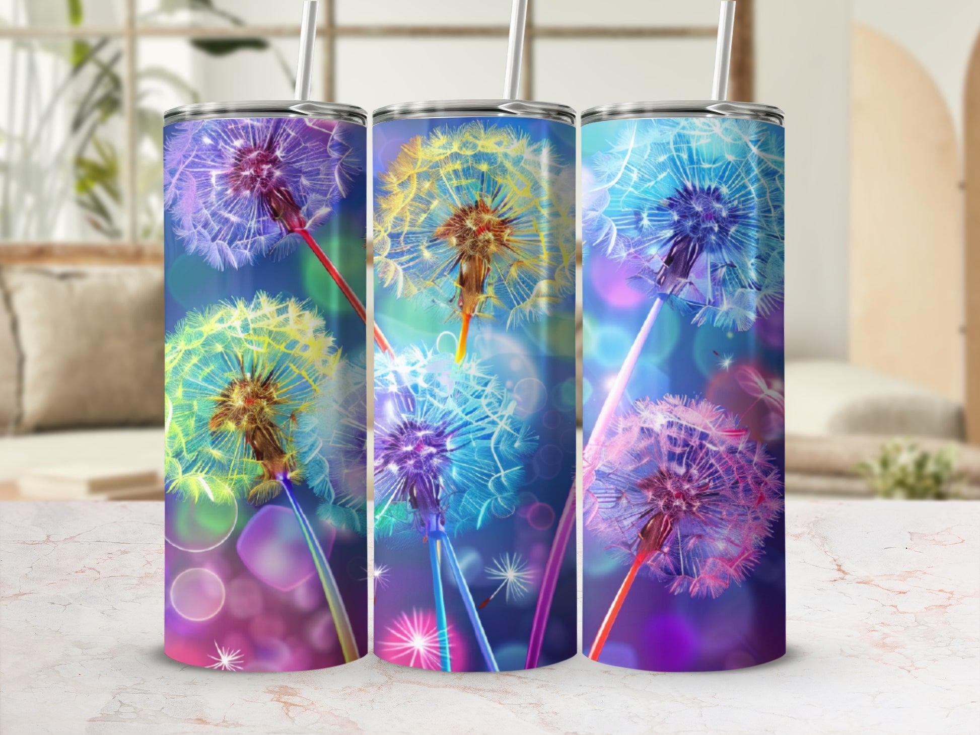 Three tumblers with dandelion designs and bokeh lighting effect.