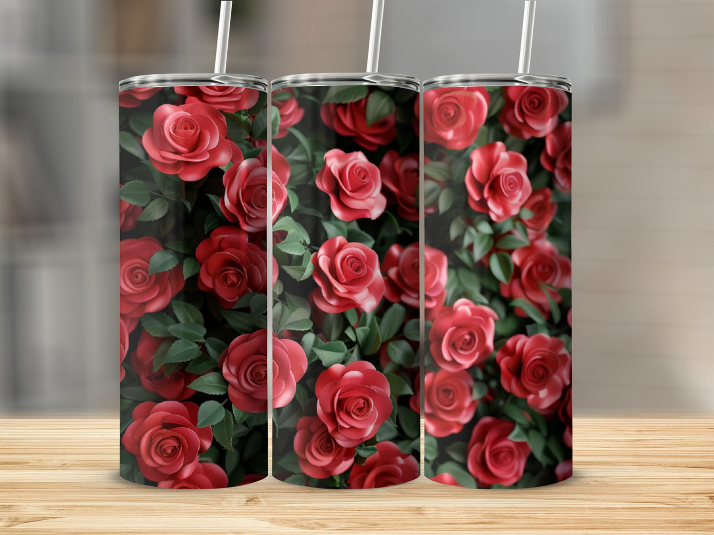 Three tumblers with a repeating pattern of red roses and green leaves.