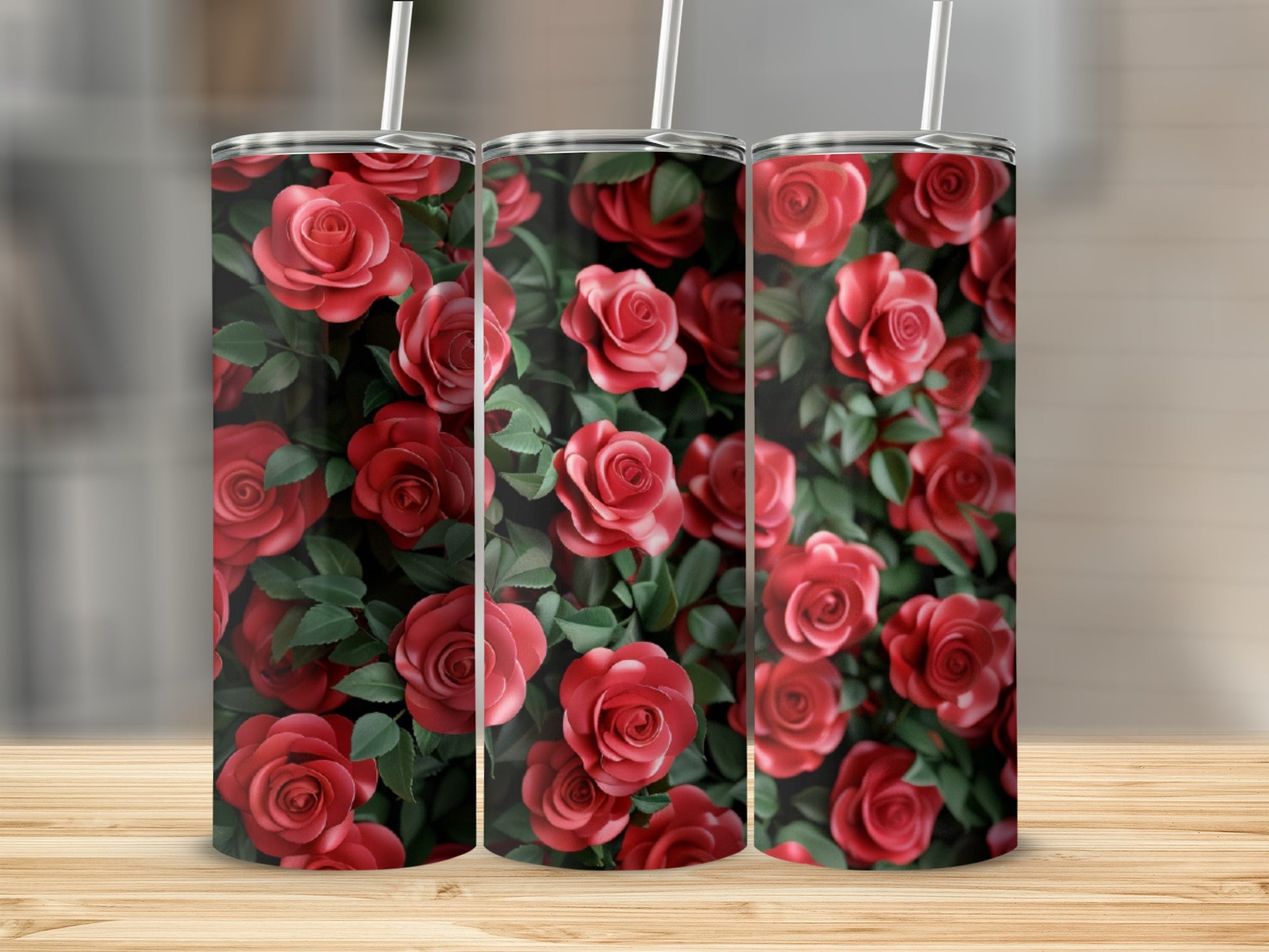 Three tumblers with a repeating pattern of red roses and green leaves.