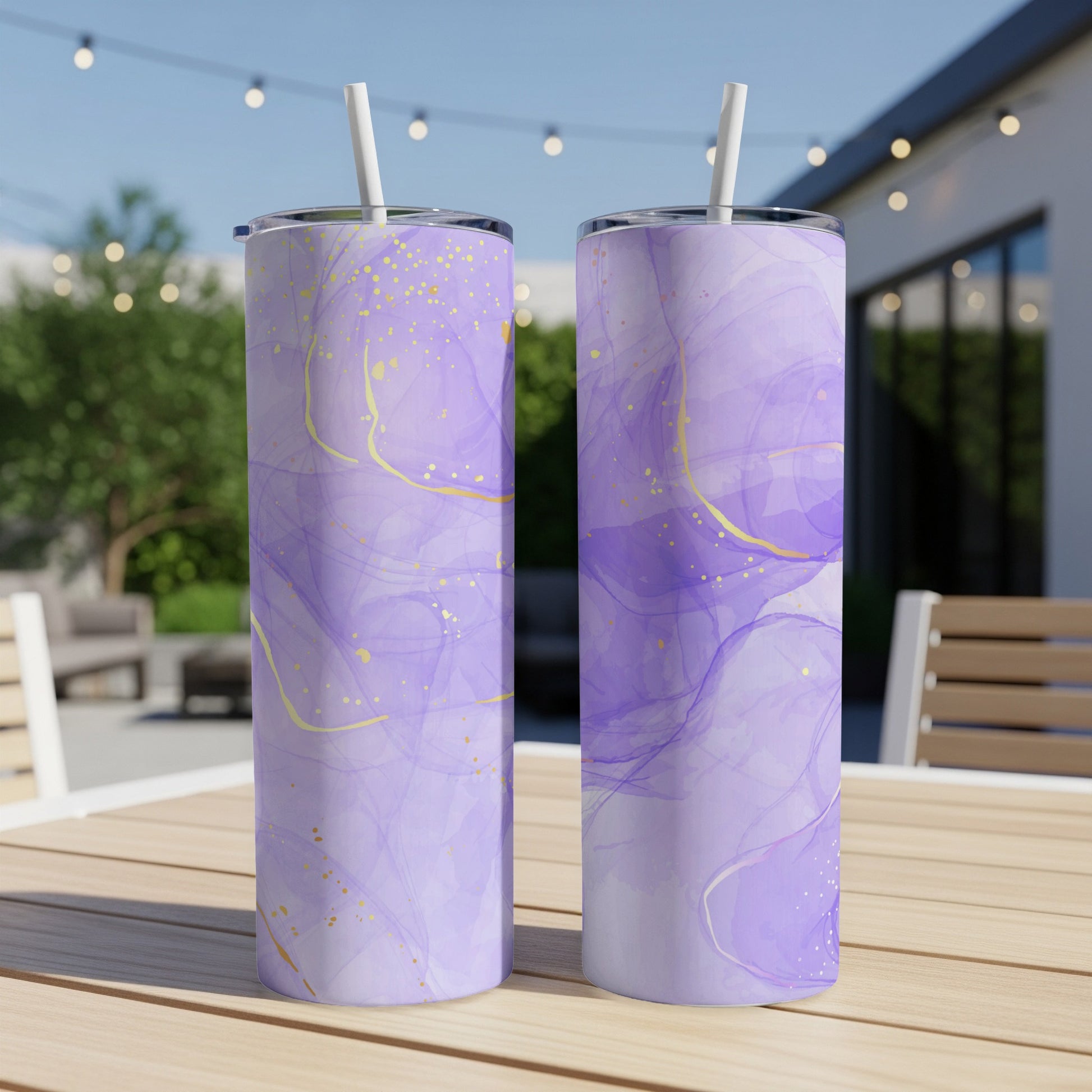 Two purple abstract marble pattern tumblers with gold accents and straws.