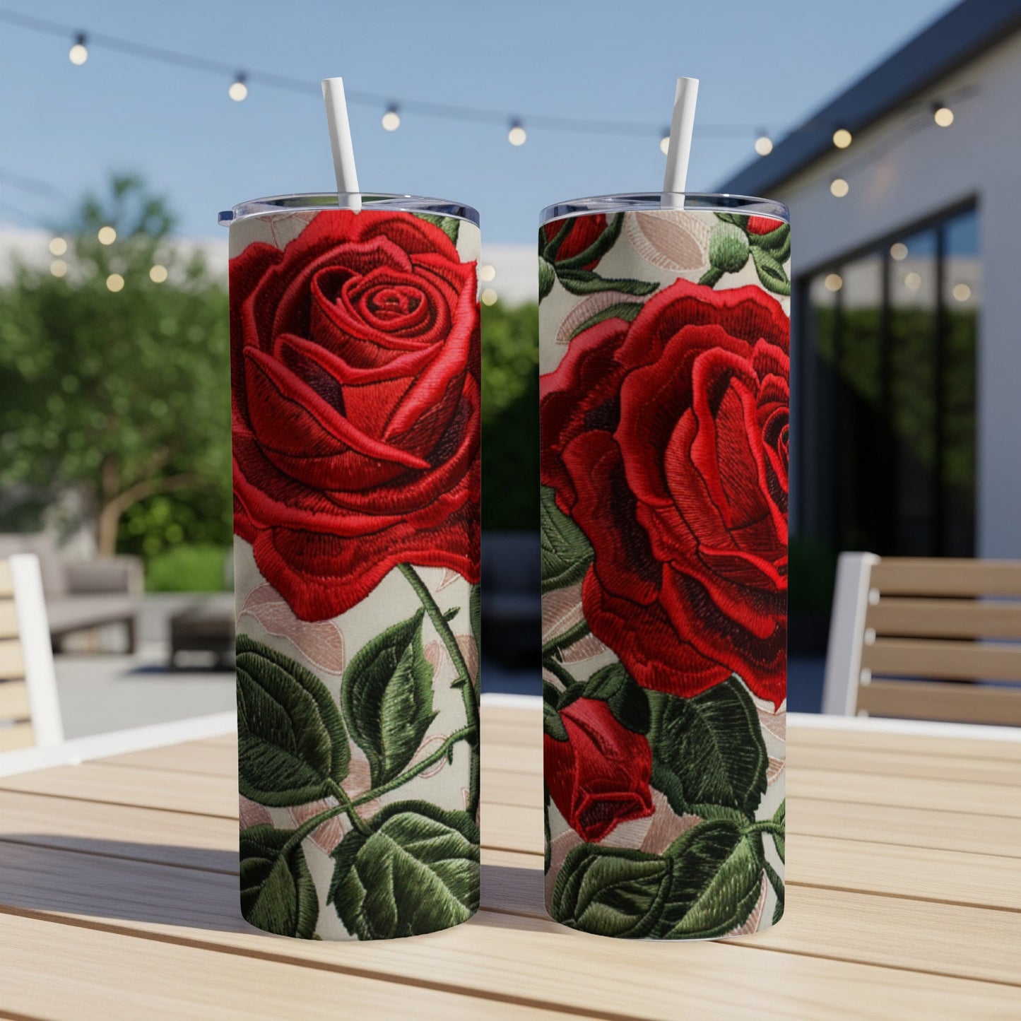 Two red roses on a patterned background, with straws.