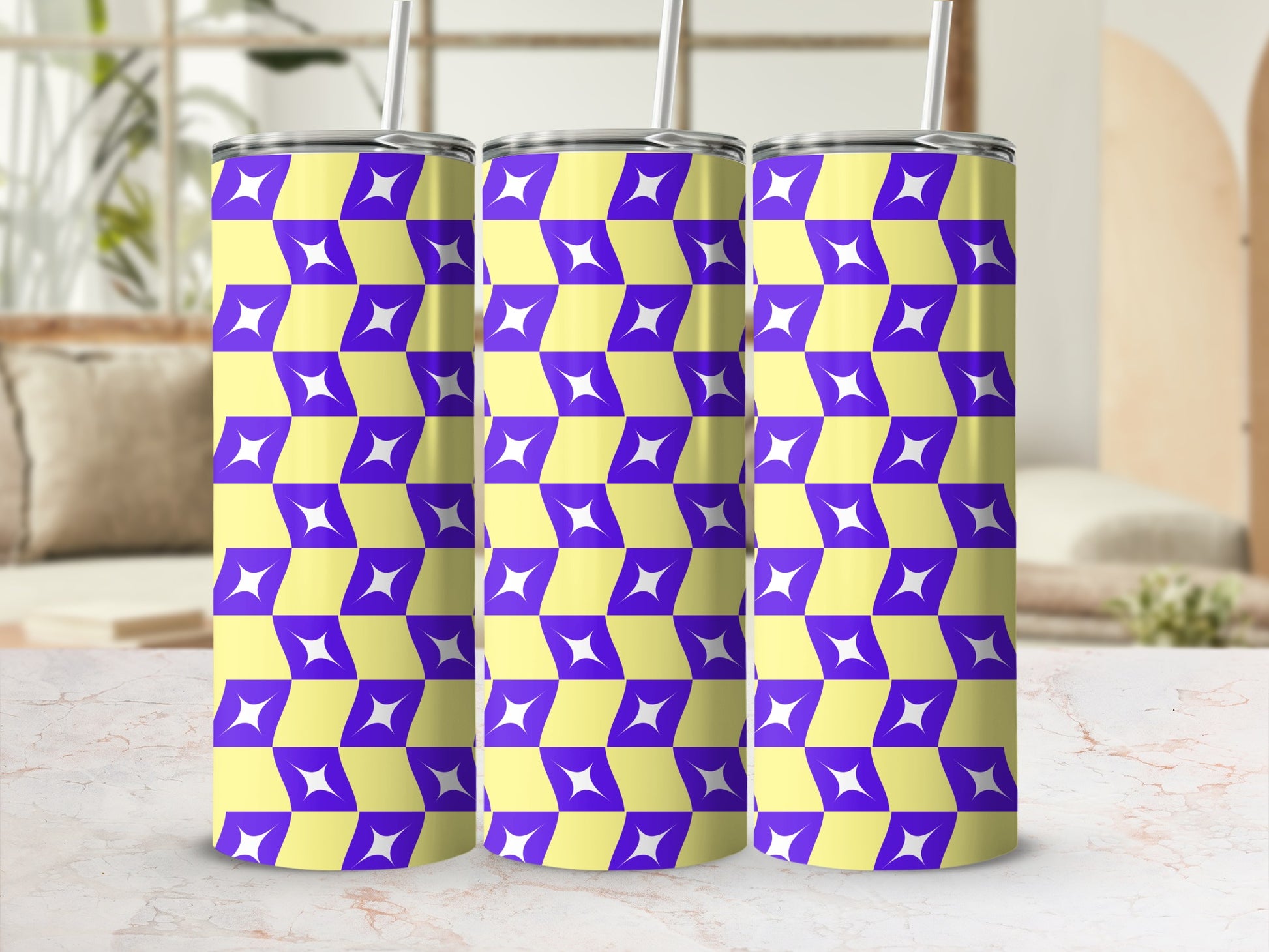 Three purple and yellow geometric pattern tumblers with straws.