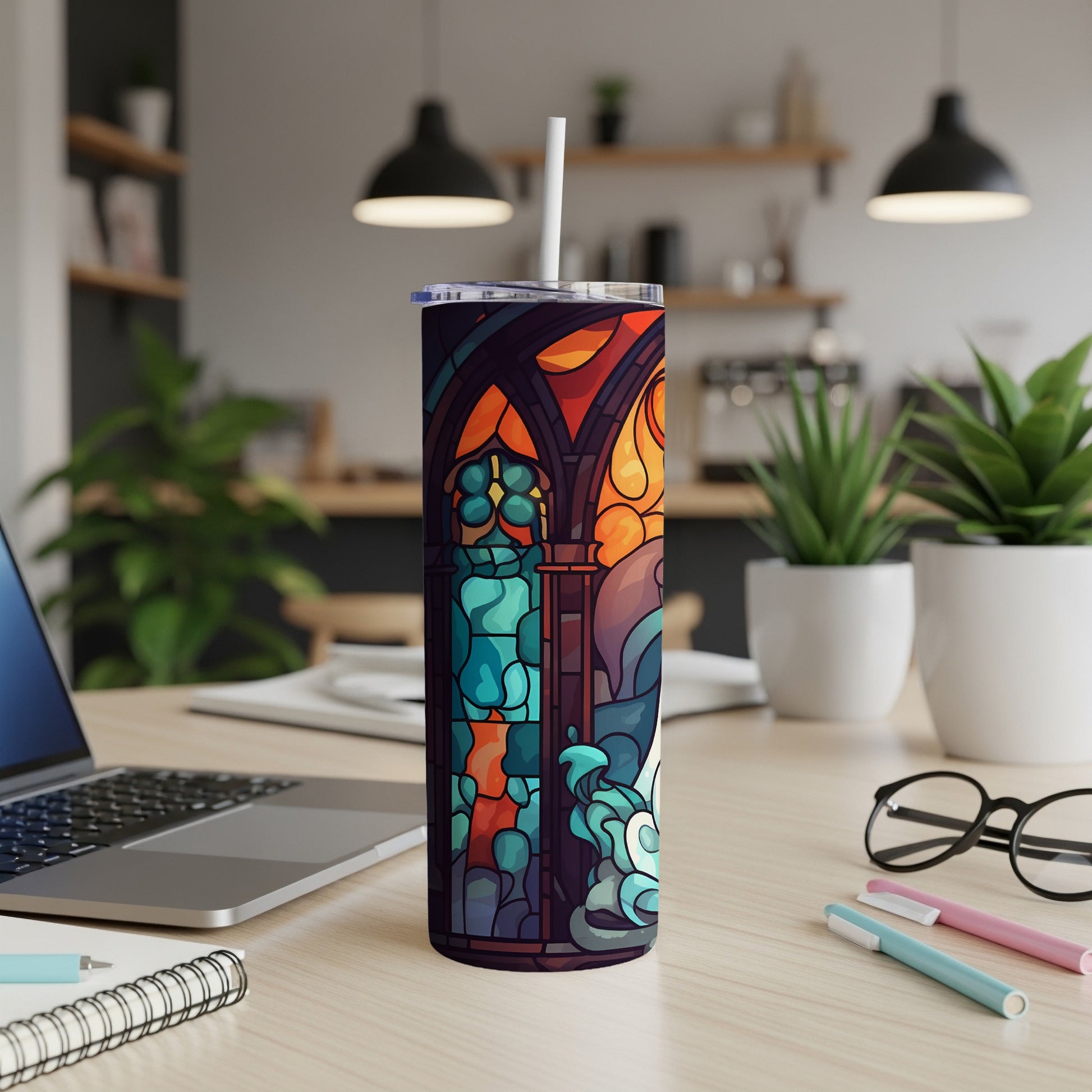 Stained glass tumbler with colorful abstract design and white straw.