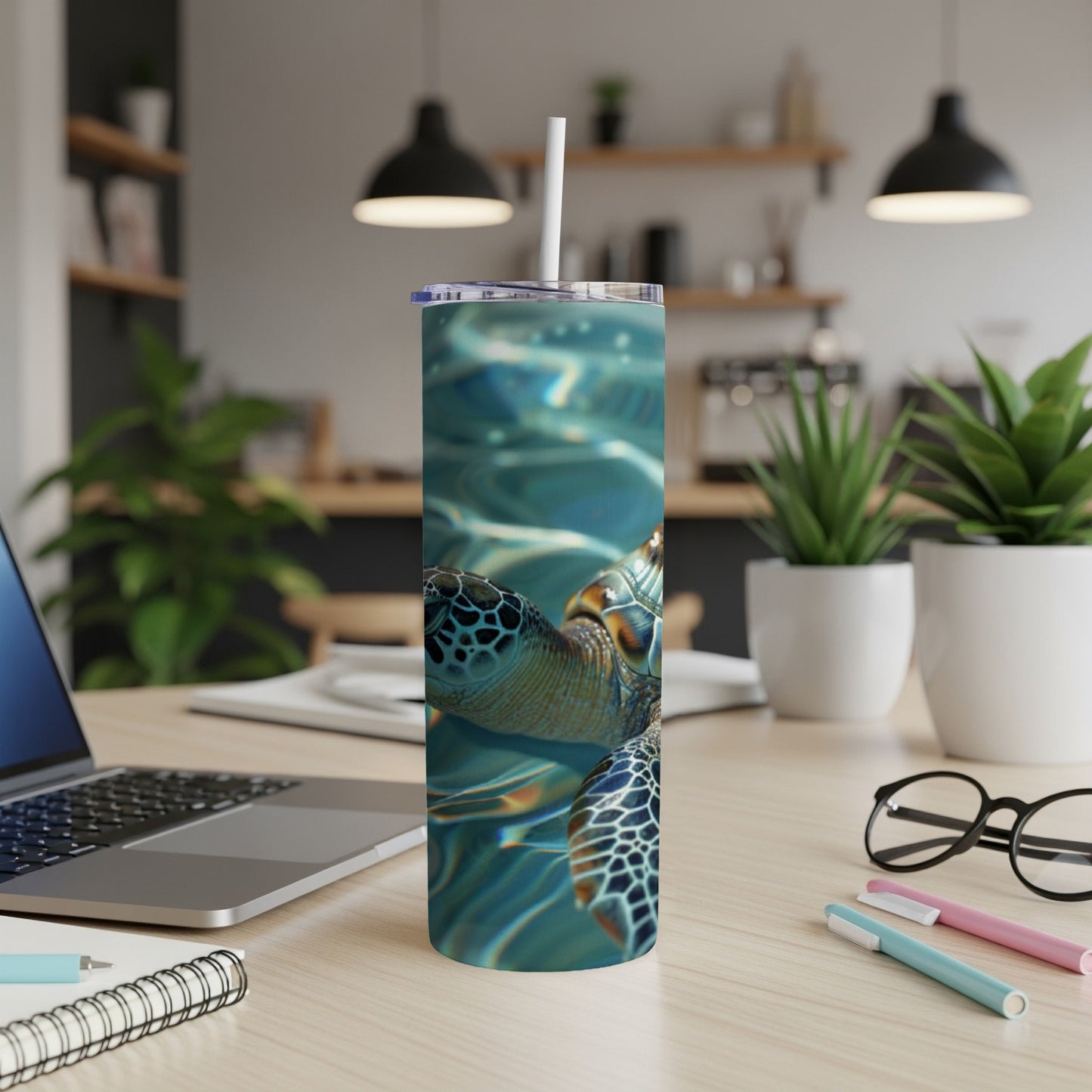 Sea turtle swimming underwater on a cylindrical tumbler with a straw.