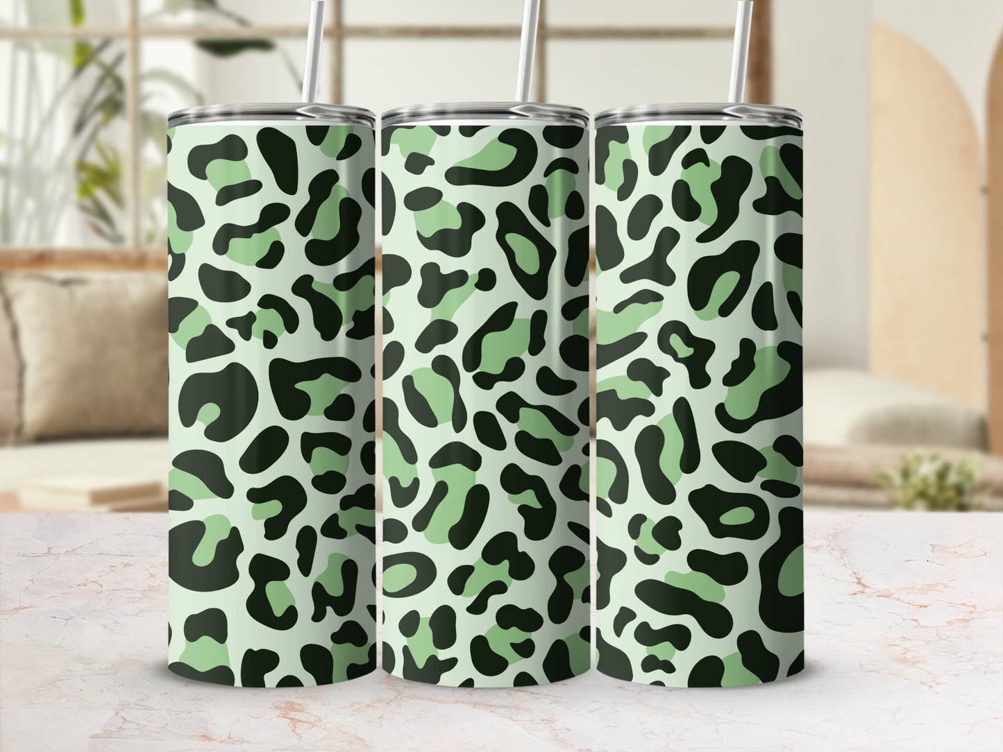 Three tumblers with a light green and black leopard print pattern.