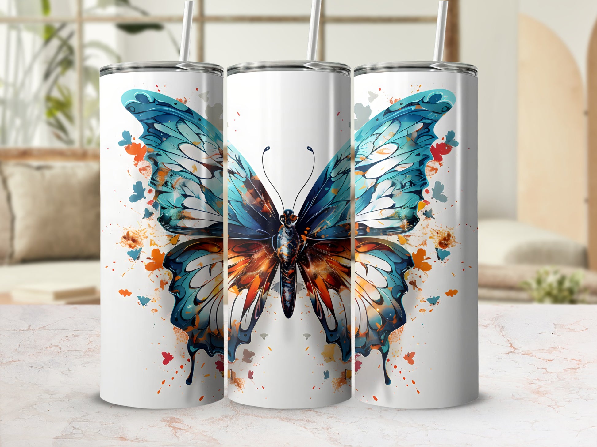White tumblers featuring a vibrant blue and orange butterfly design with paint splatters.