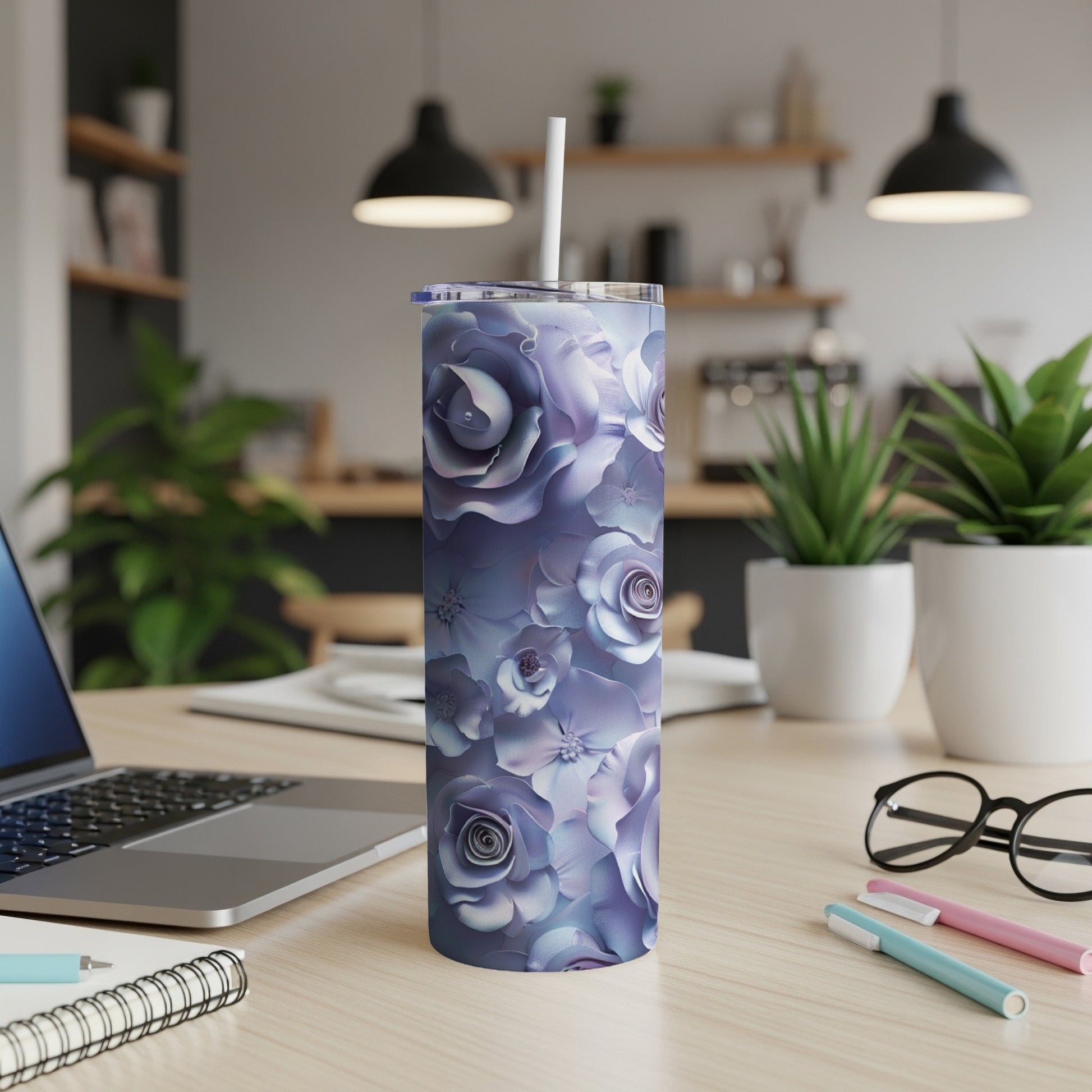 Purple floral tumbler with white straw on a desk.