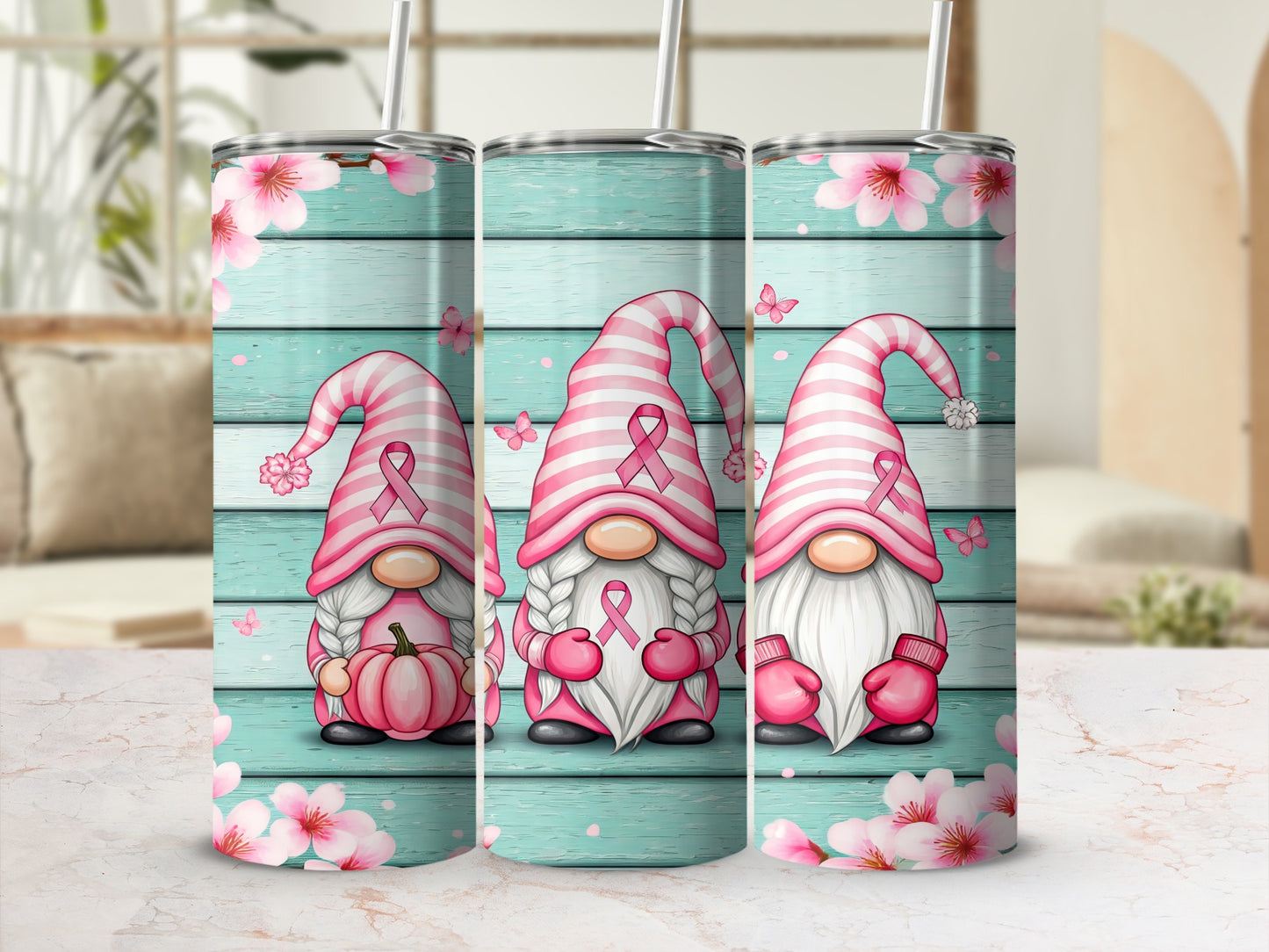 Three gnomes in pink striped hats with ribbon accents on a wooden background with flowers.