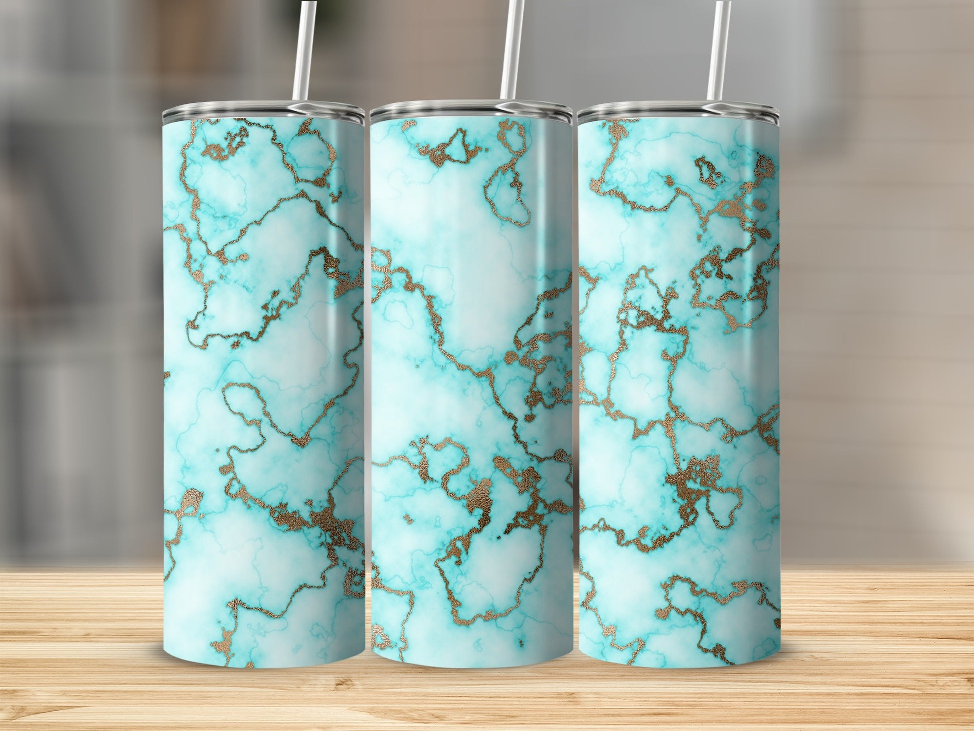 Three tumblers with blue and gold marble patterns displayed on a wooden surface.