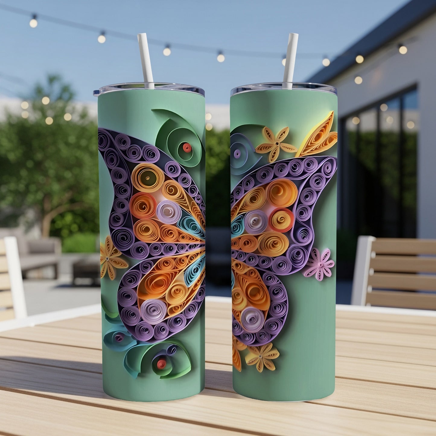 Two green tumblers with butterfly wing designs made from quilled paper.
