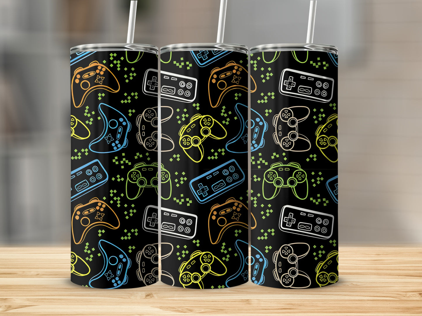 Three tumblers with a repeating pattern of colorful video game controllers.