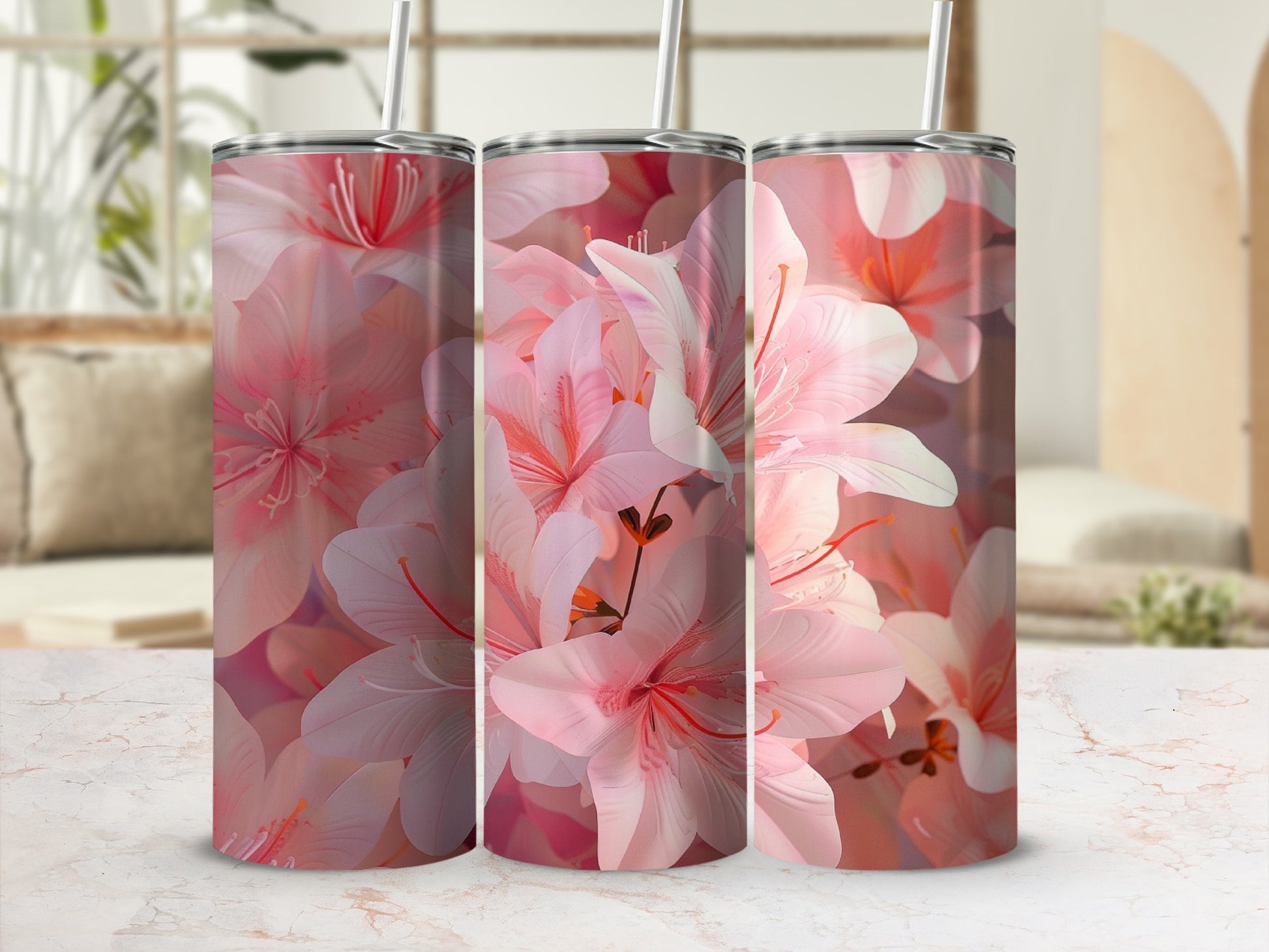 Three tumblers with a pink floral pattern and straws.