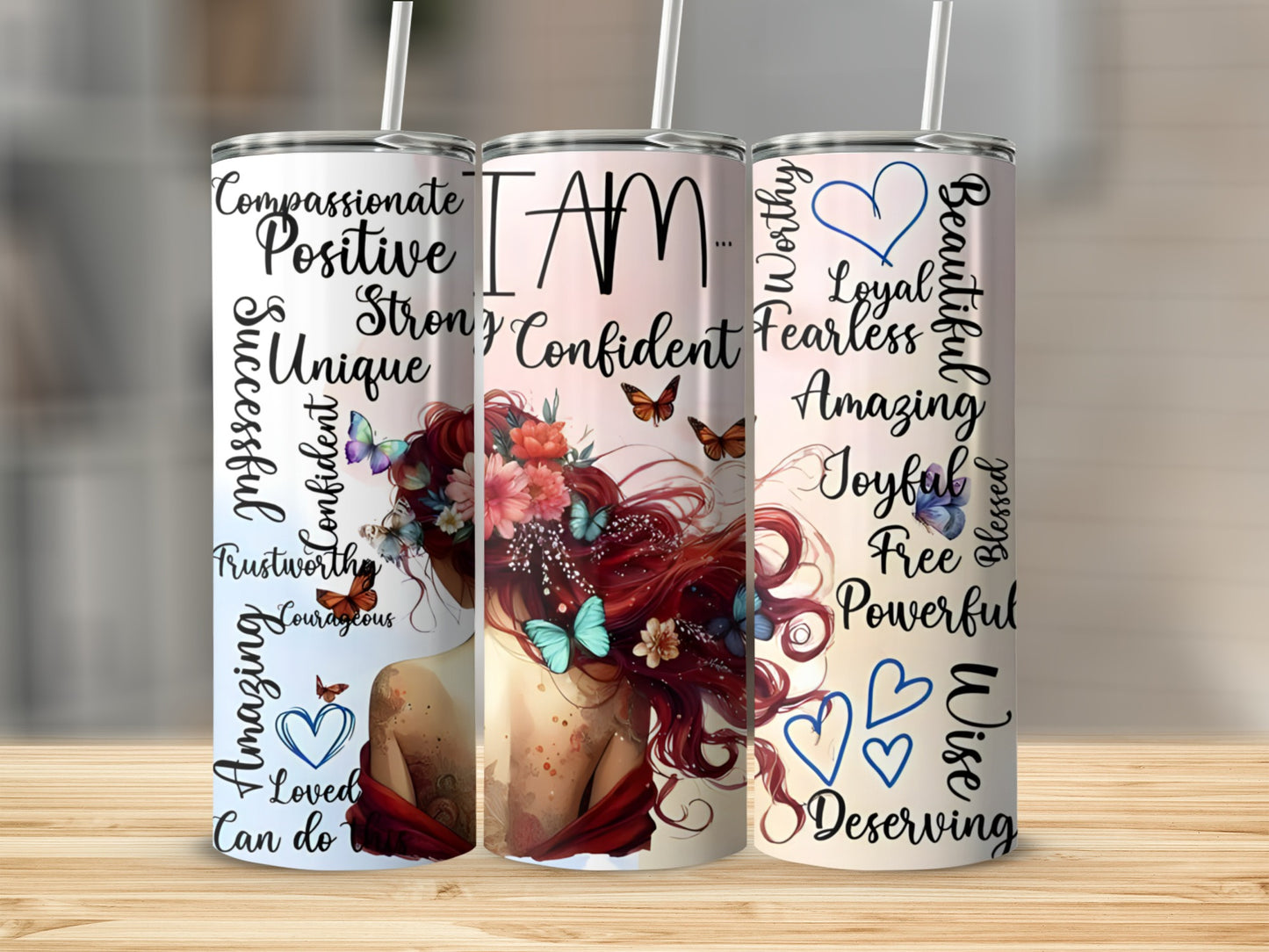 Tumbler with "I AM" and positive affirmations surrounded by butterflies and flowers.