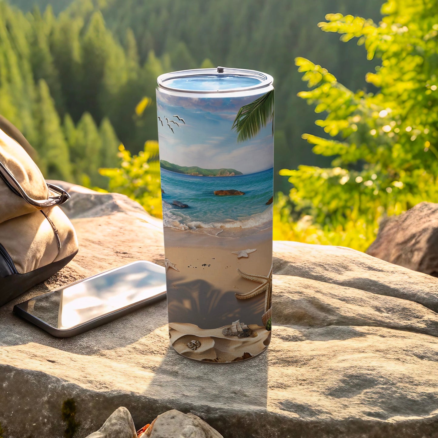 Beach scene printed on a stainless steel tumbler with a backpack and phone.