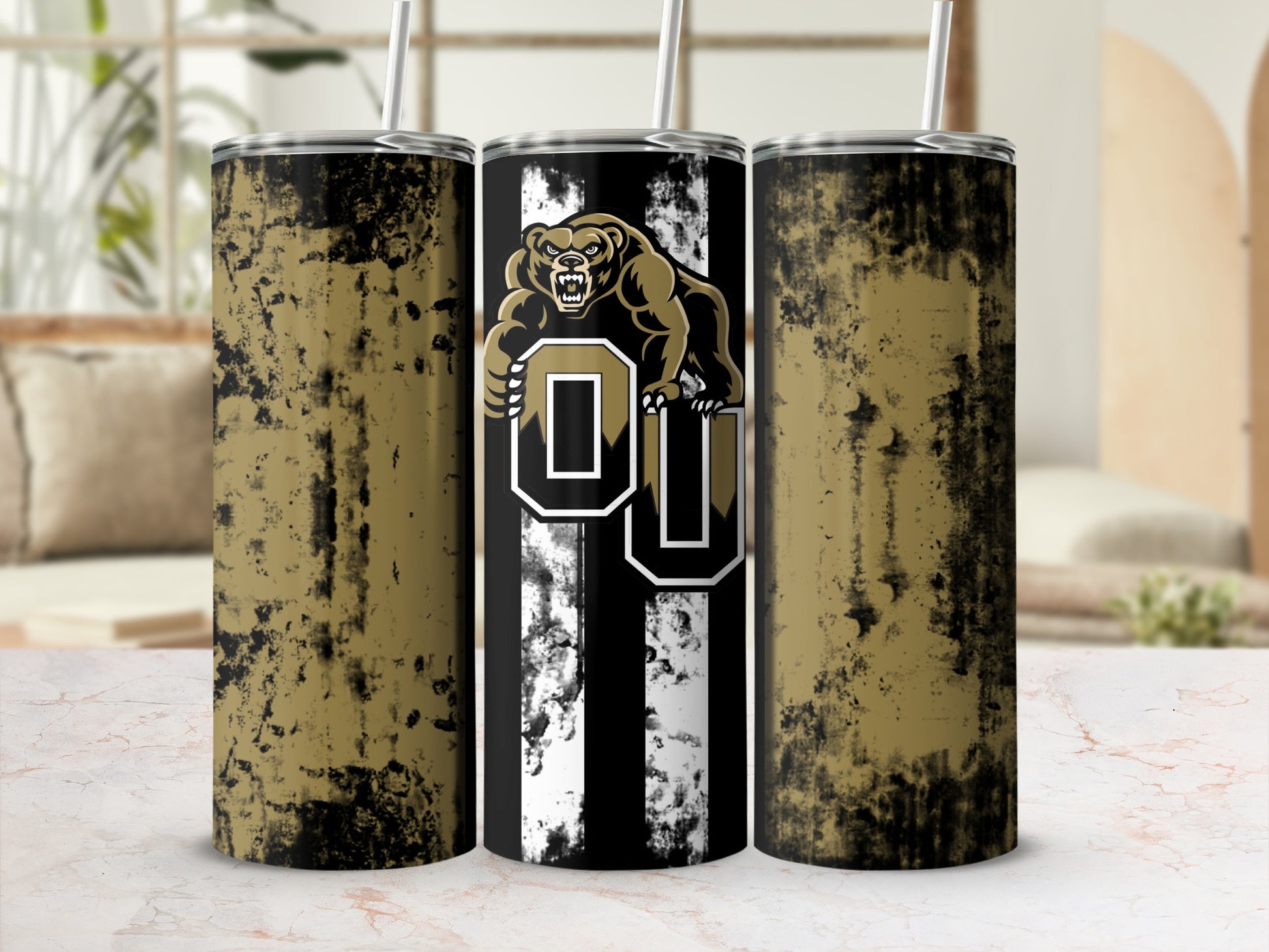 Three tumblers, two with distressed gold and black texture, one with bear and OU logo.