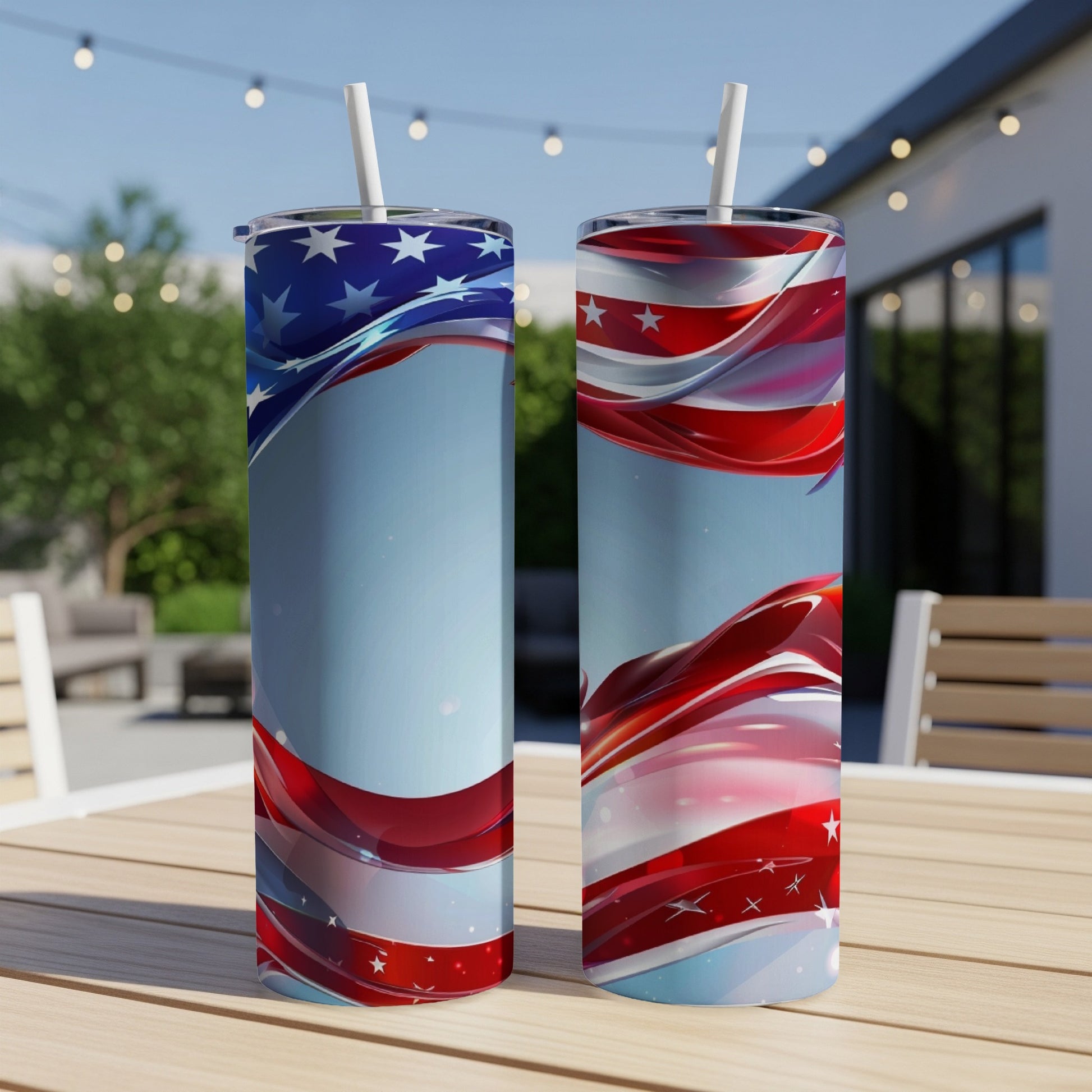Two patriotic tumblers with swirling American flag design on outdoor table.