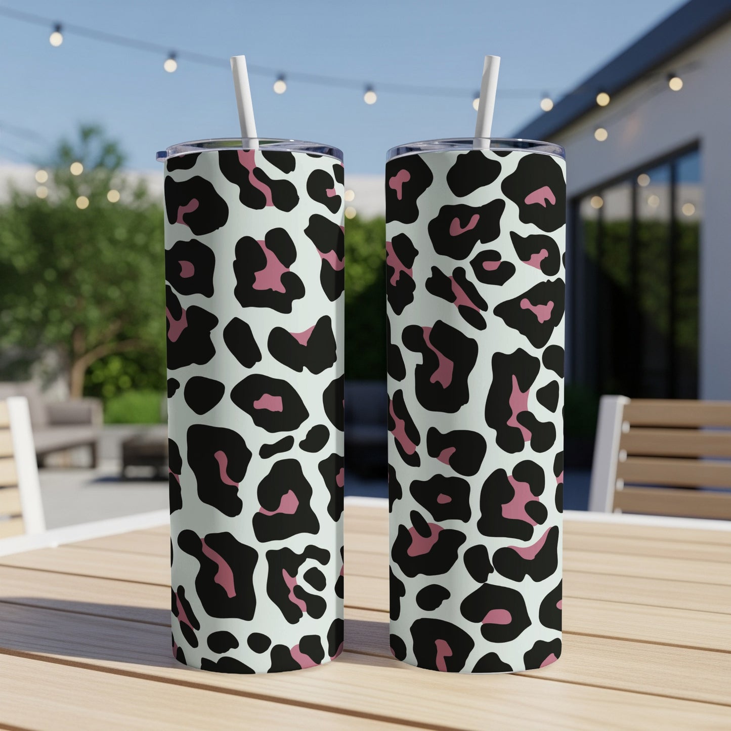 Two tumblers with light mint background and black and pink leopard print patterns.