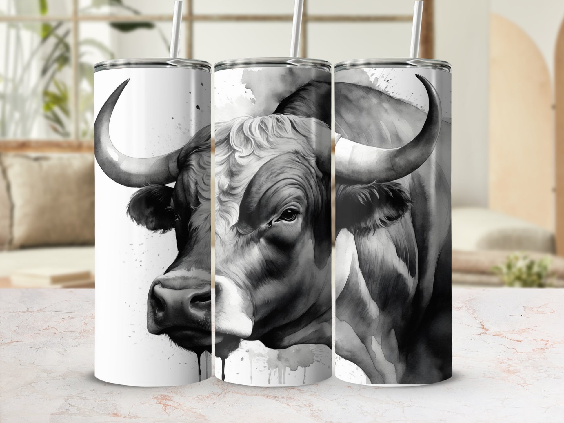 Black and white watercolor bull art on a stainless steel tumbler.