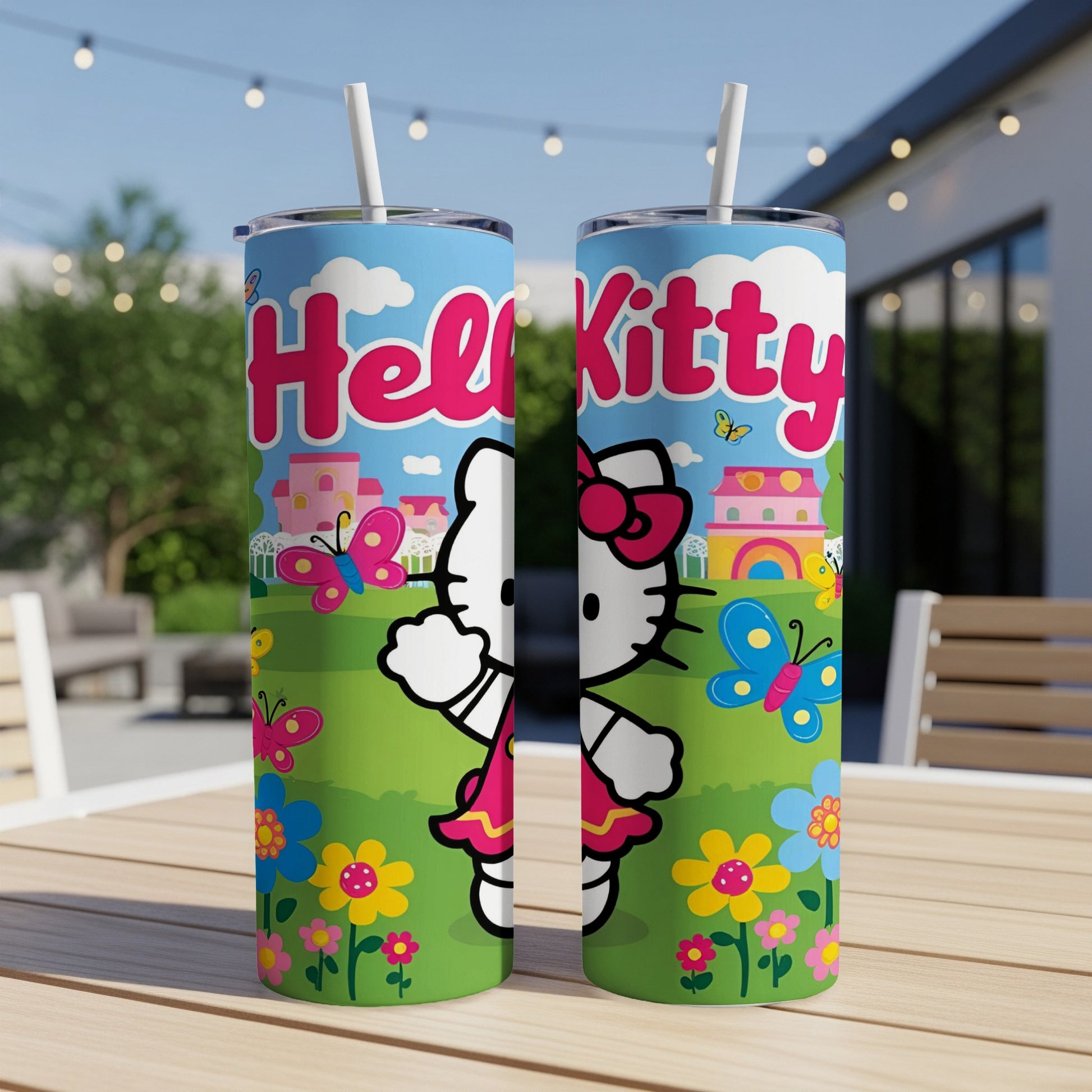 Hello Kitty tumbler with butterflies and flowers, on outdoor table.