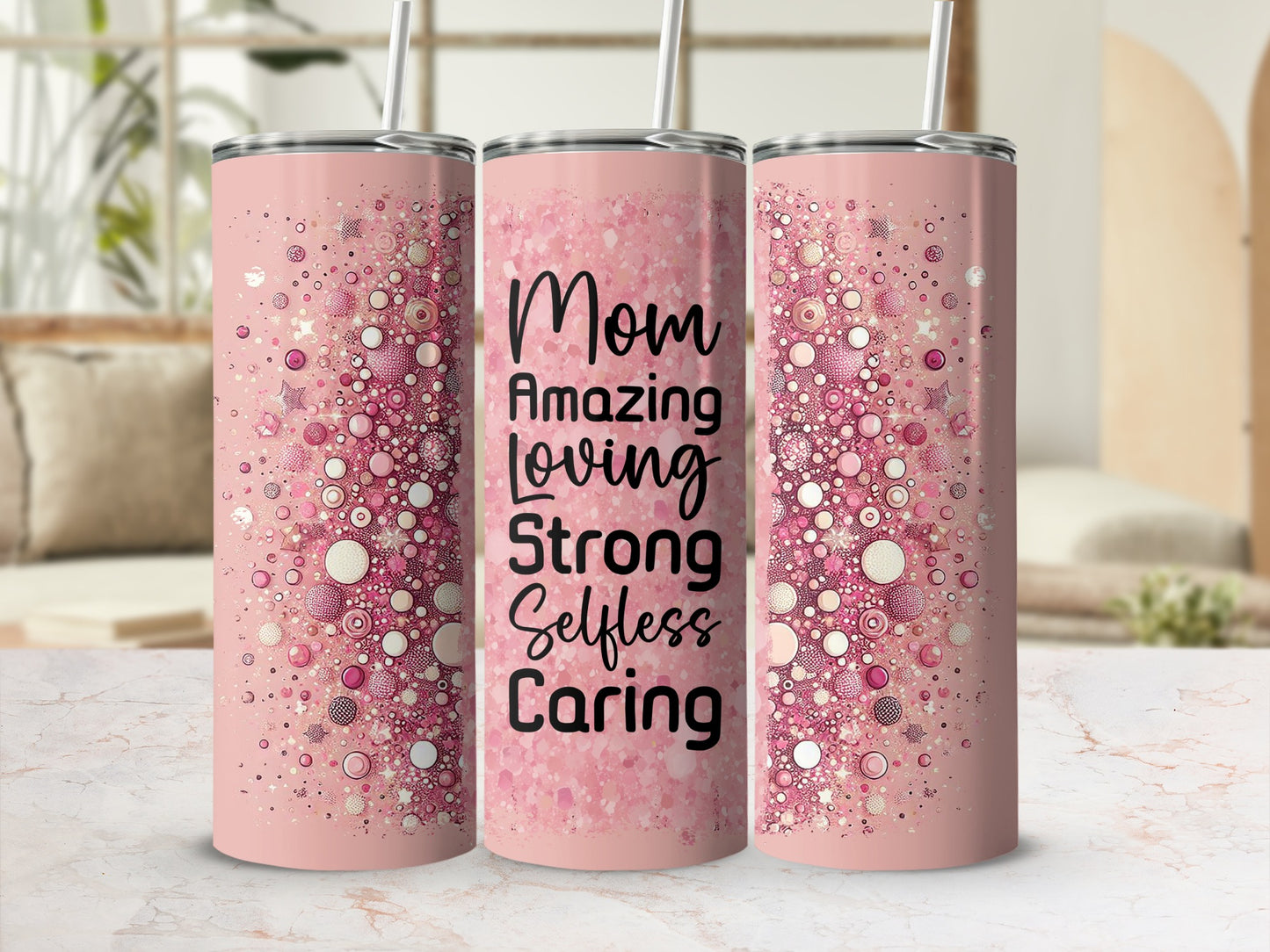 Pink tumbler with "Mom Amazing Loving Strong Selfless" text and glitter design.