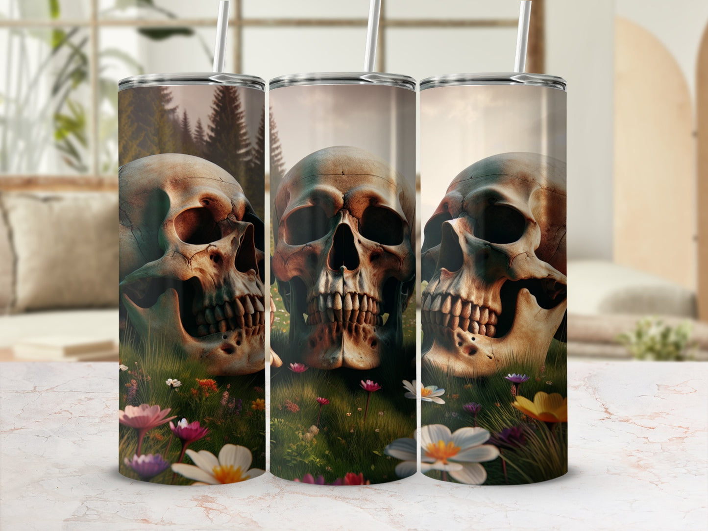 Three tumblers with skull and floral designs on a marble surface.