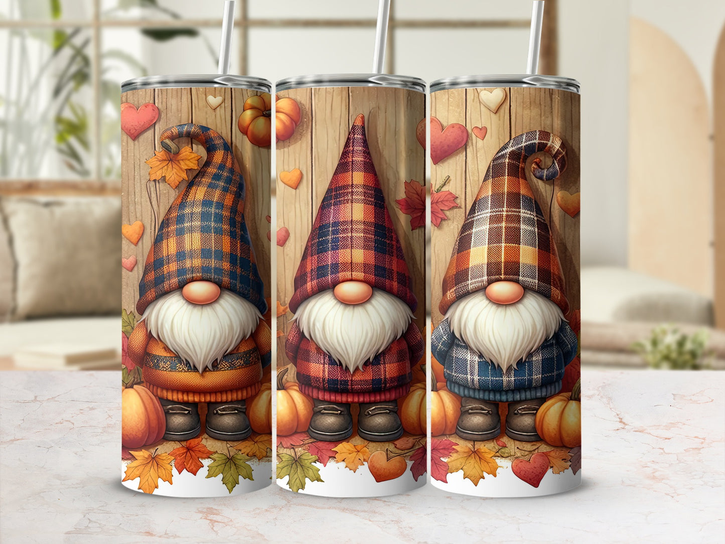 Three decorative tumblers featuring plaid gnomes, autumn leaves, and pumpkins.