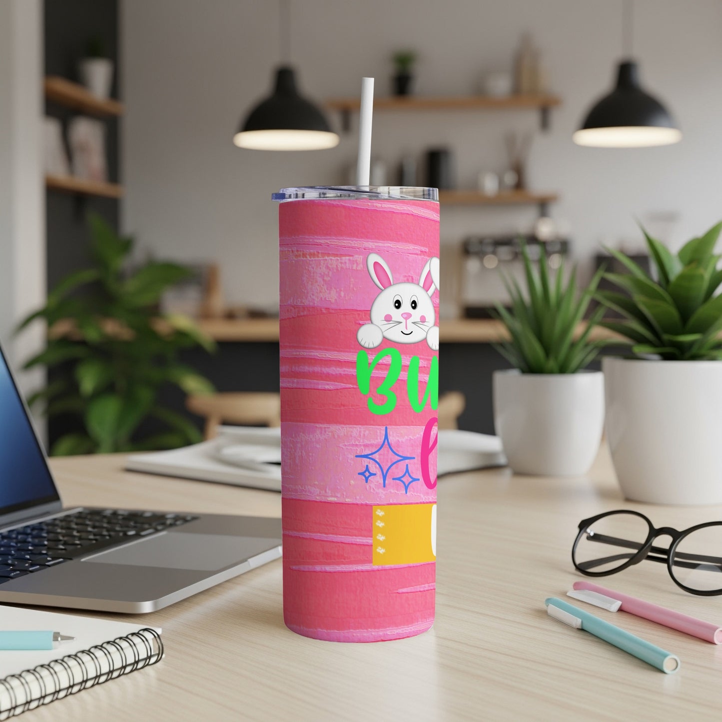Pink tumbler with a bunny and "Bunny Vibes" text on a desk.