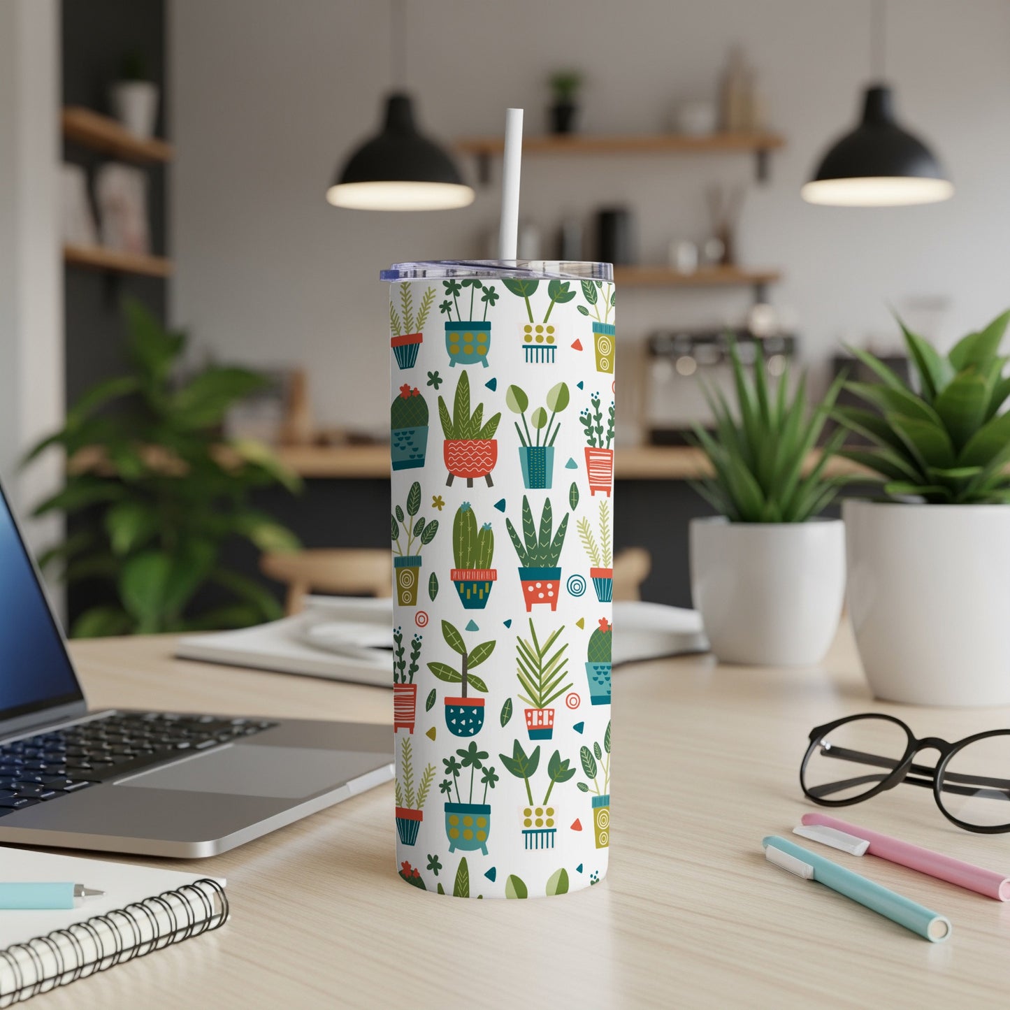 White tumbler with a pattern of various potted houseplants and geometric shapes.