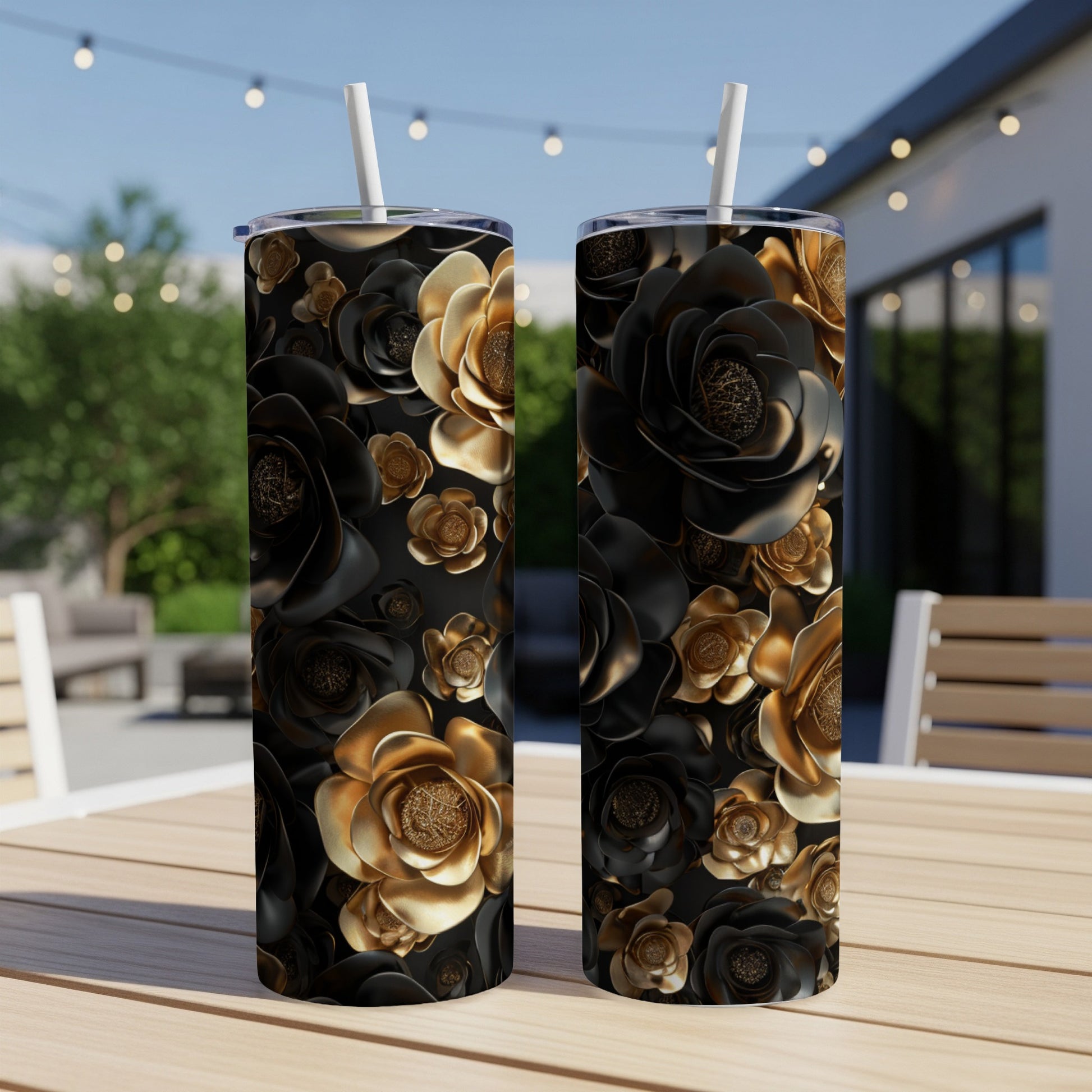Two black and gold rose patterned tumblers on a wooden table.