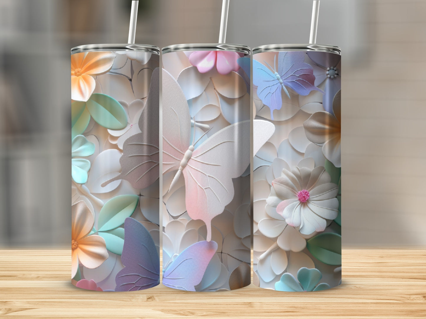 Three tumblers with pastel floral and butterfly designs.