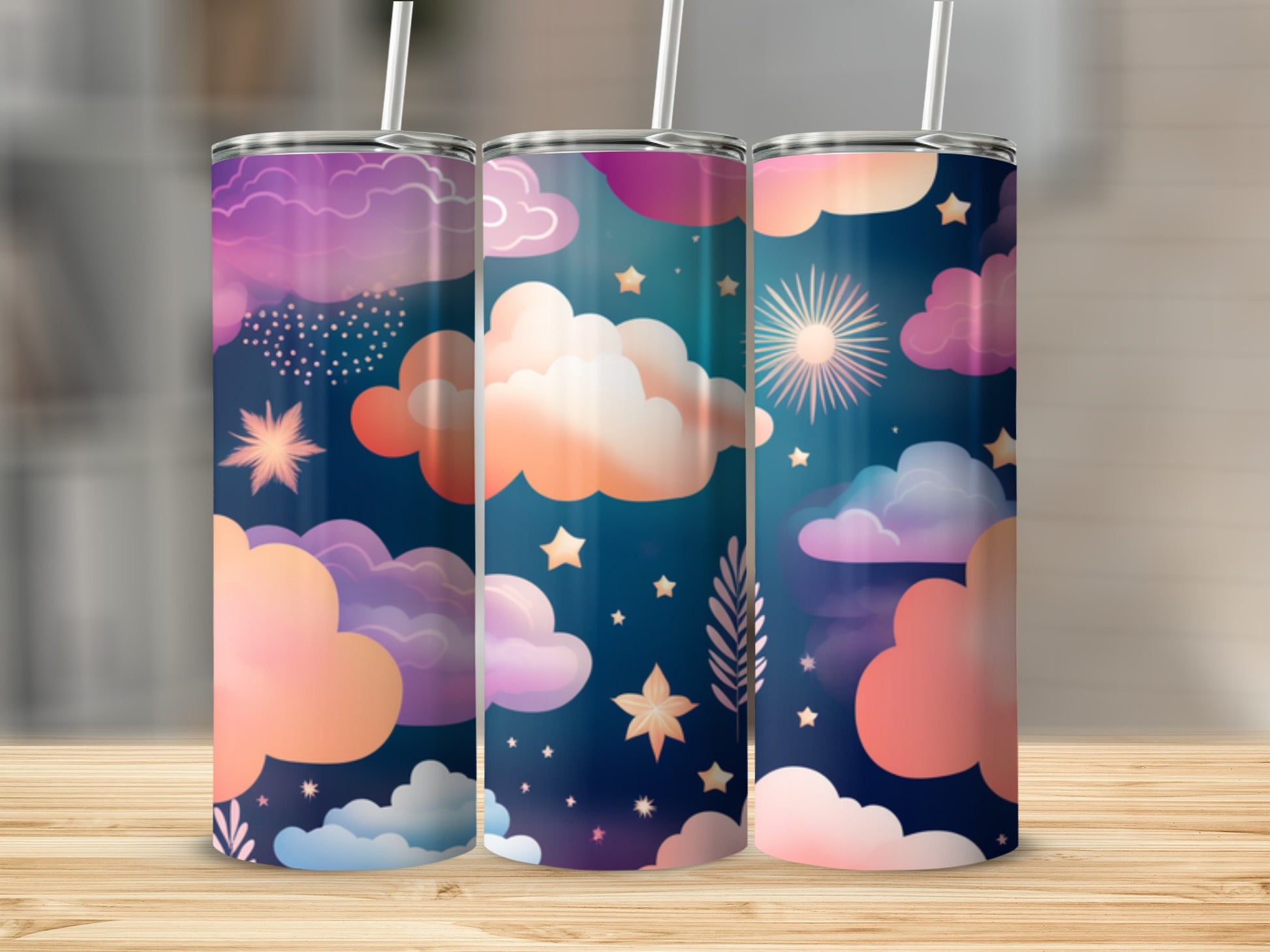Three tumblers with a celestial cloud and star pattern in purple and pink hues.