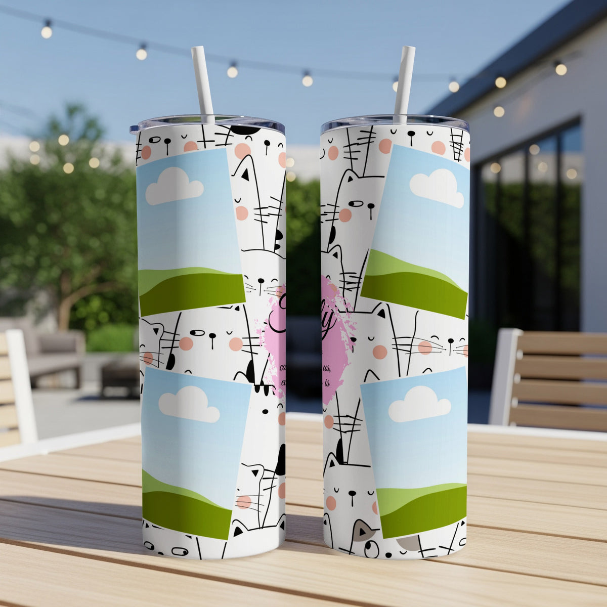 Two tumblers with a repeating pattern of cartoon cats, clouds, and green hills.