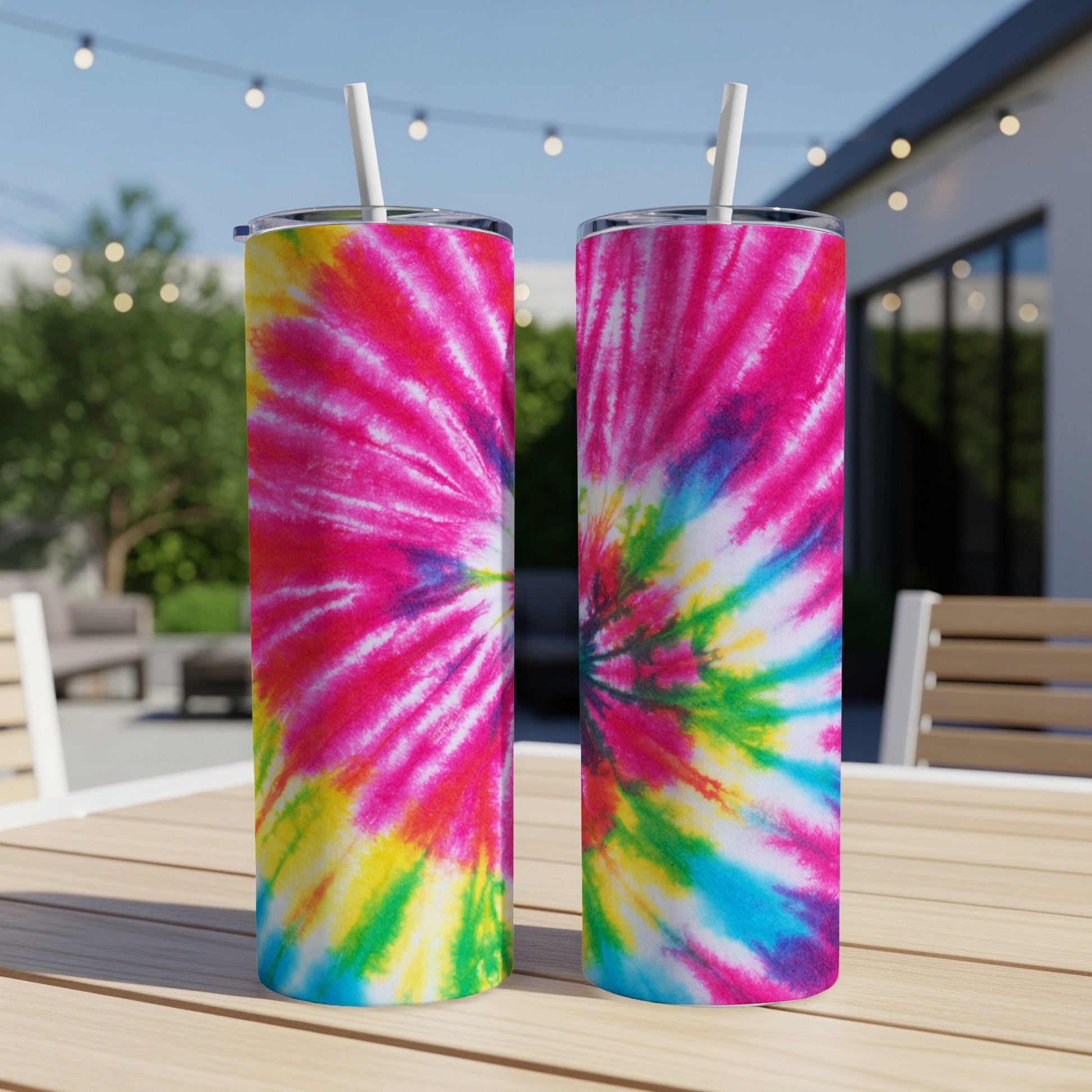 Two tall tumblers with vibrant pink, blue, yellow, and green tie-dye patterns.