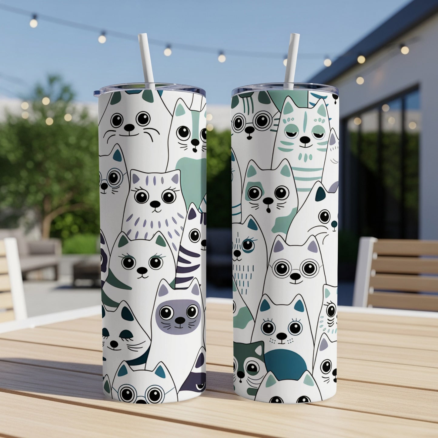 Two tall tumblers with repeating pattern of various cartoon cats.