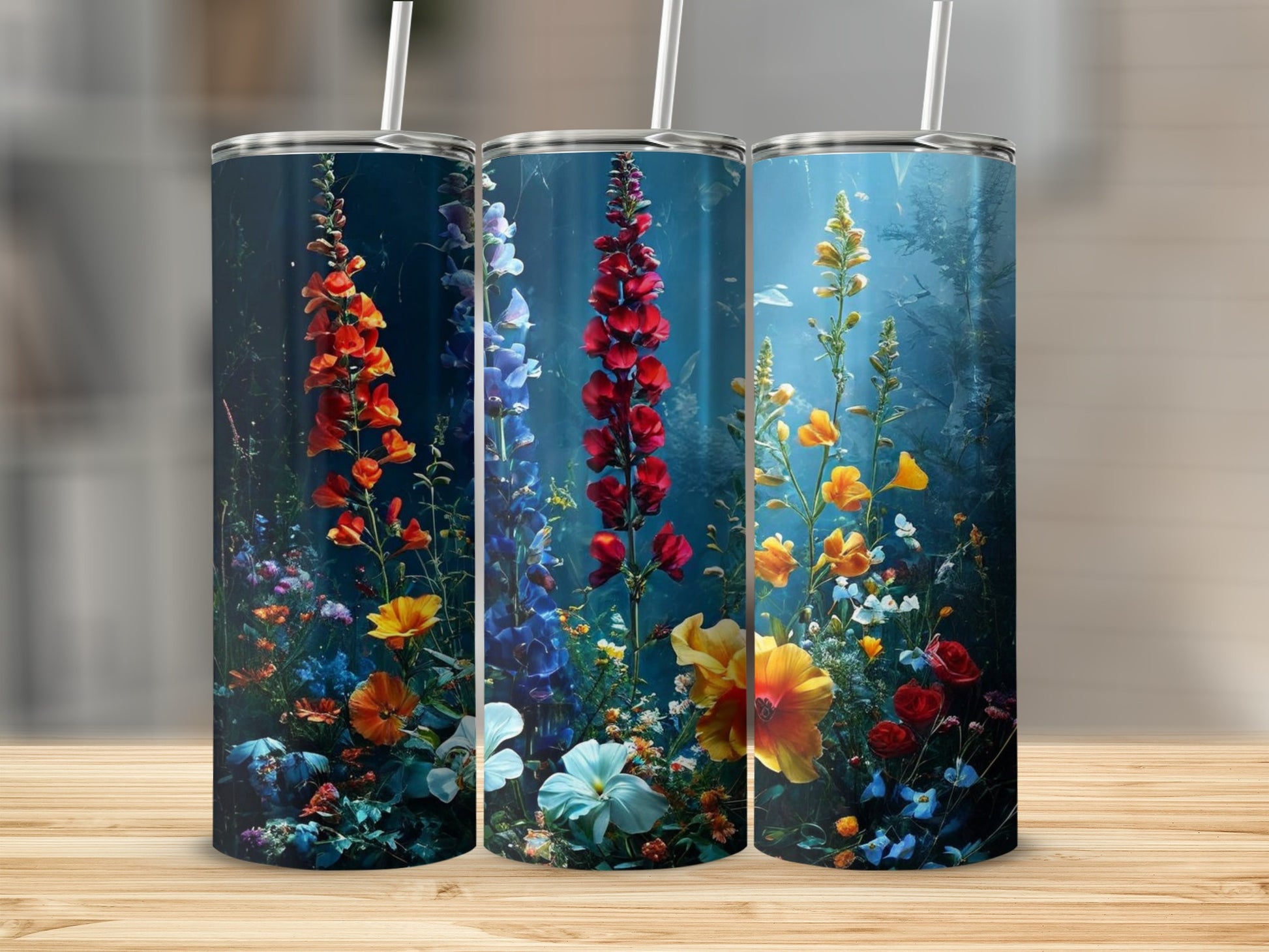 Three tumblers with vibrant floral designs featuring foxgloves and other wildflowers.