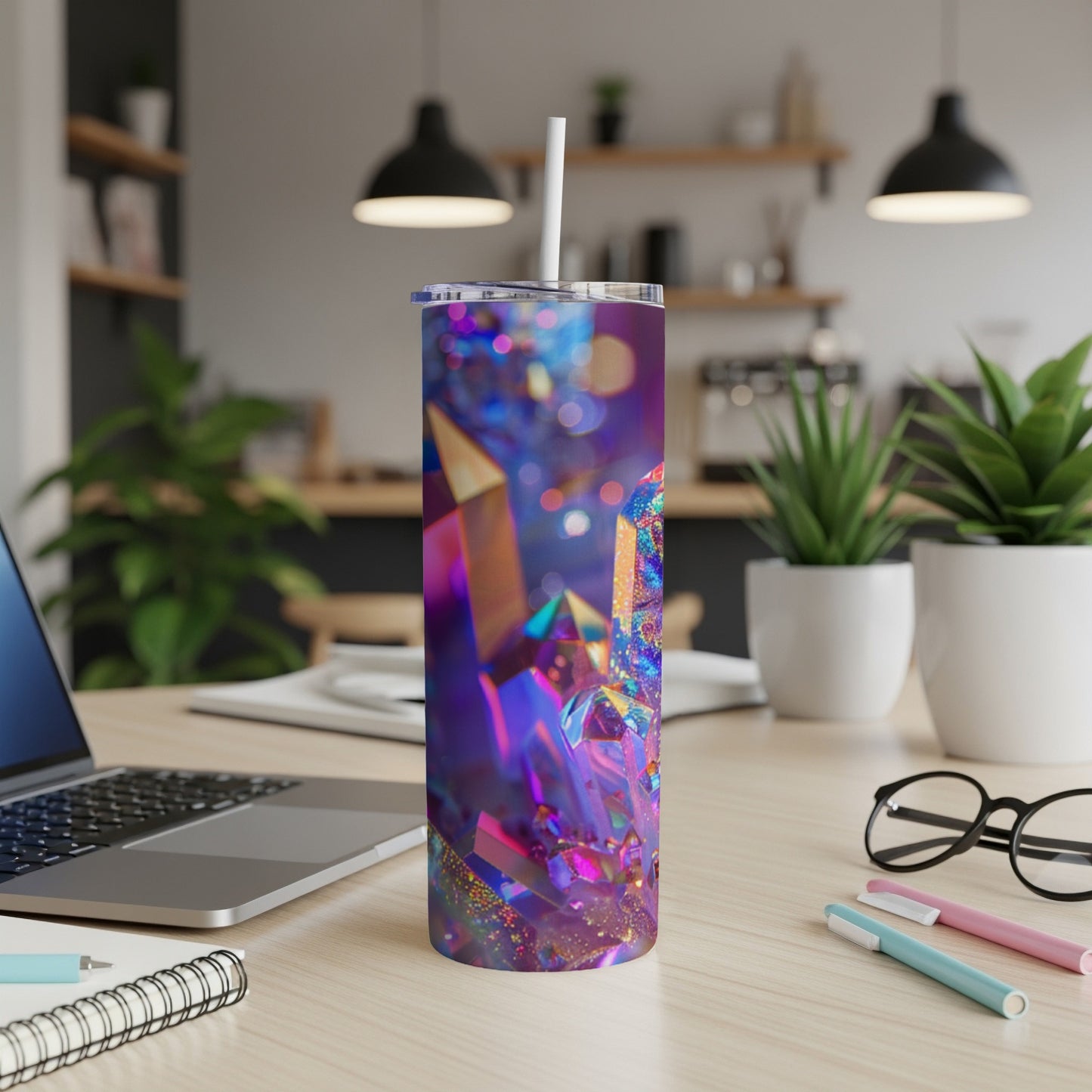 Tumbler with iridescent crystal pattern and straw on a desk.