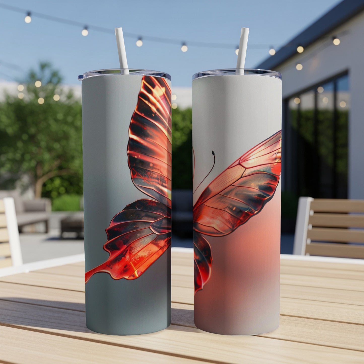 Two tumblers with iridescent red butterfly wings on a light gray background.