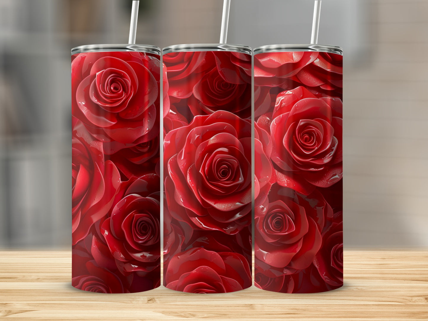 Three red rose tumblers with straws on a wooden surface.