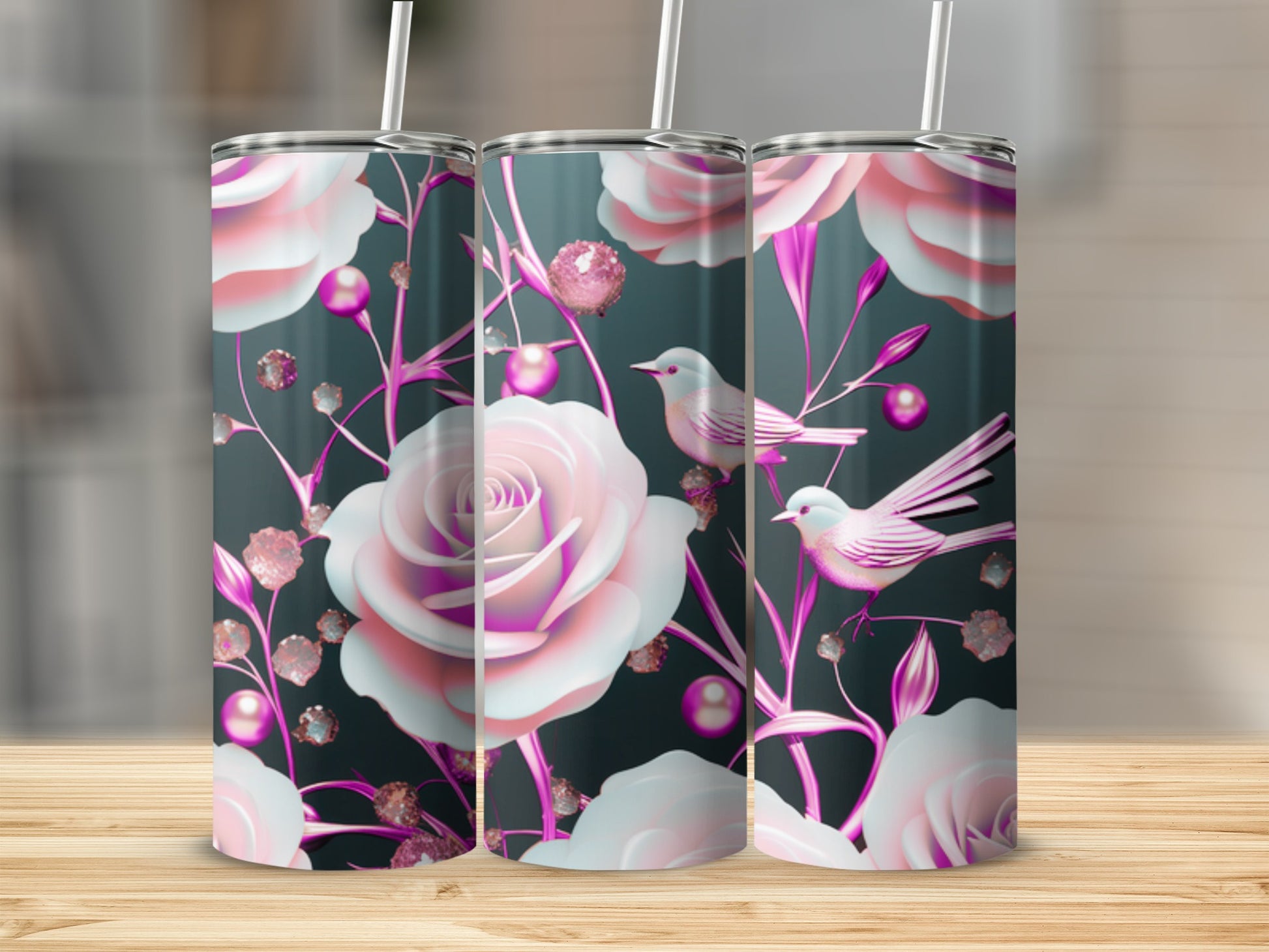 Pink roses and birds design on three tumblers against a dark background.