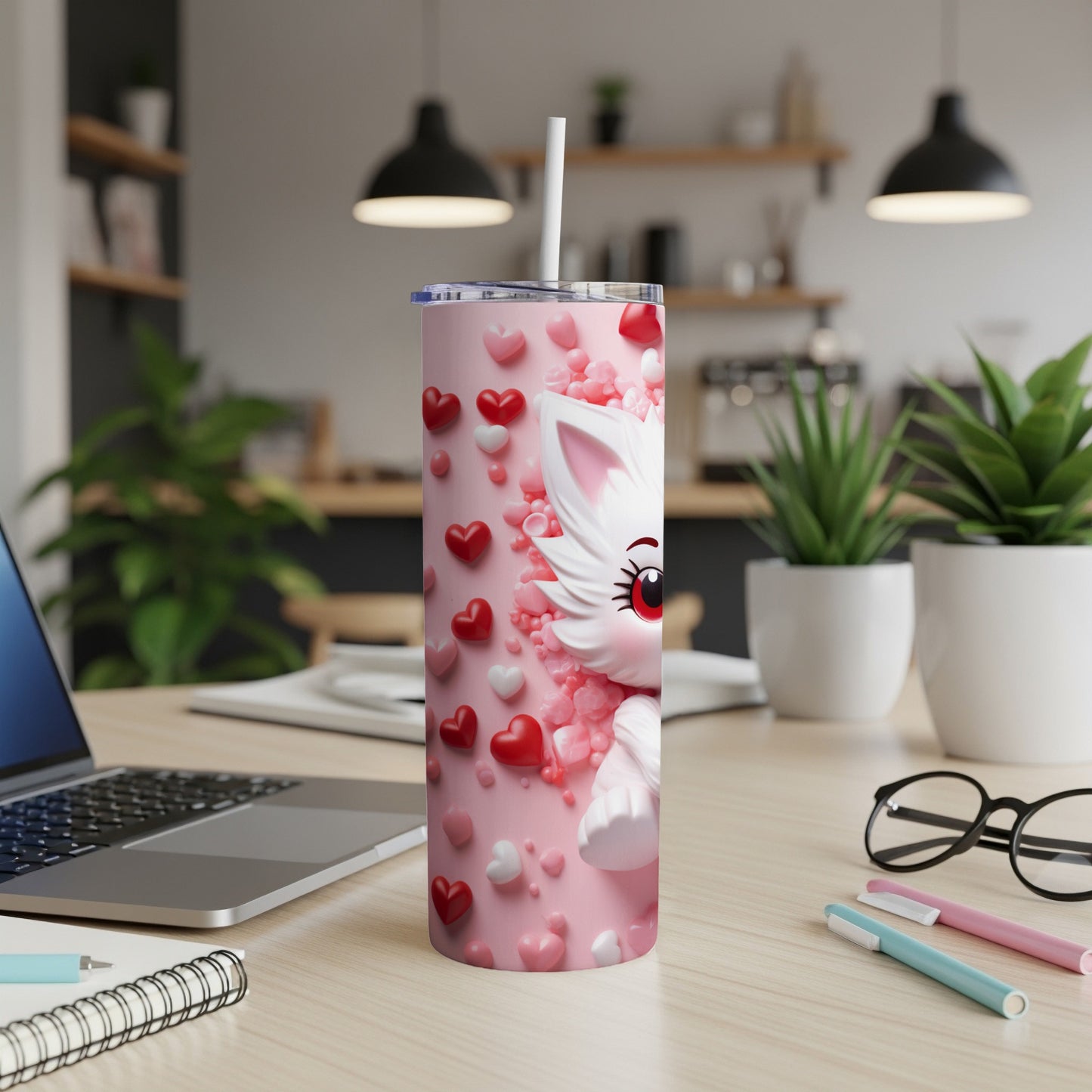 Pink tumbler with cartoon cat and hearts, white straw.