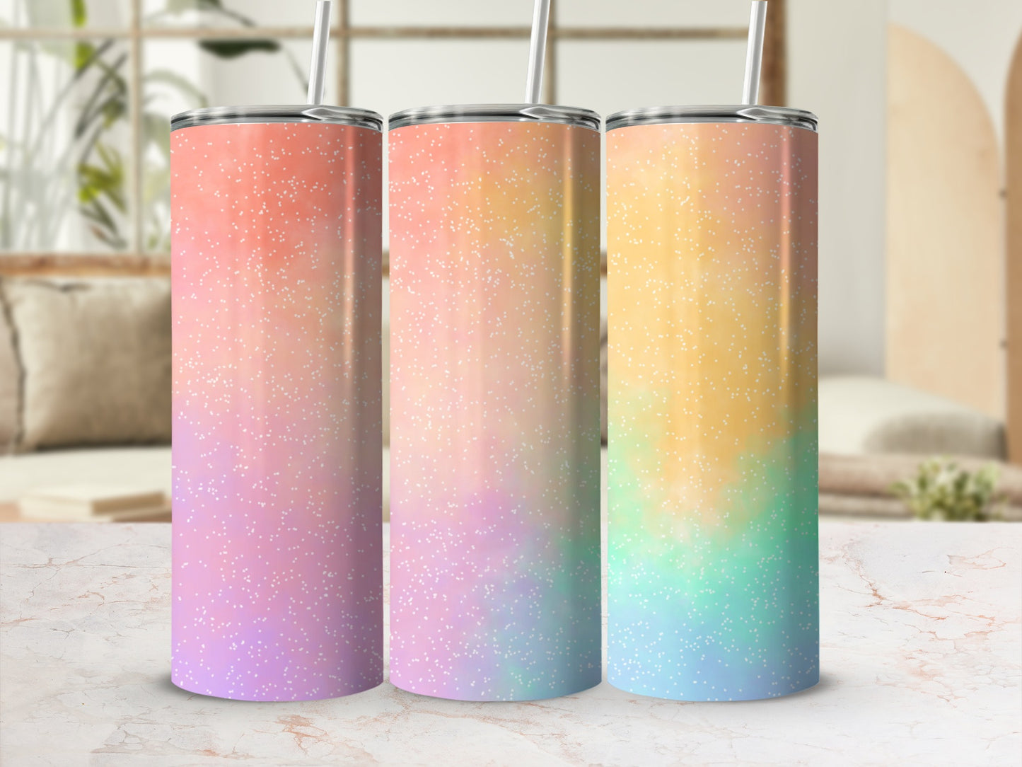 Three tumblers with pastel ombre glitter patterns and straws.