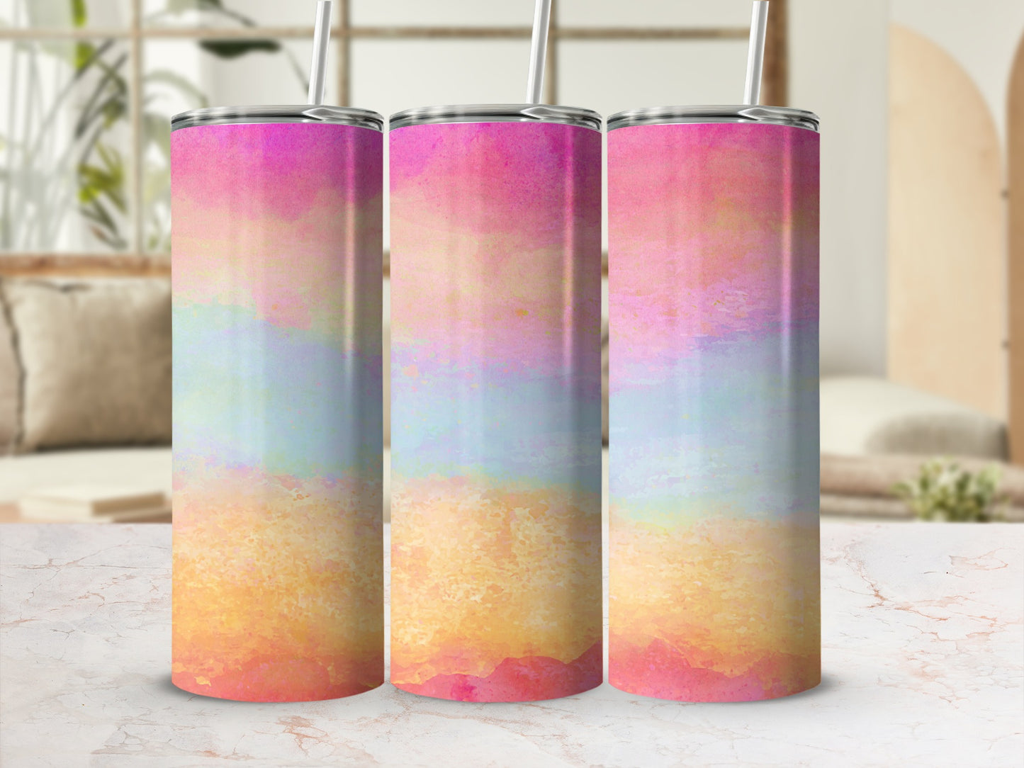 Three tumblers with a pink, orange, and blue watercolor design and metal lids.
