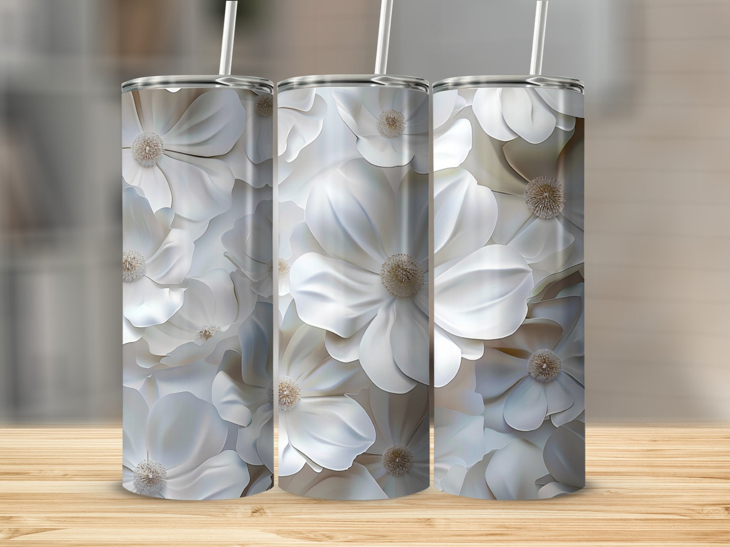 Three tall tumblers with a white floral pattern sit on a wooden surface.